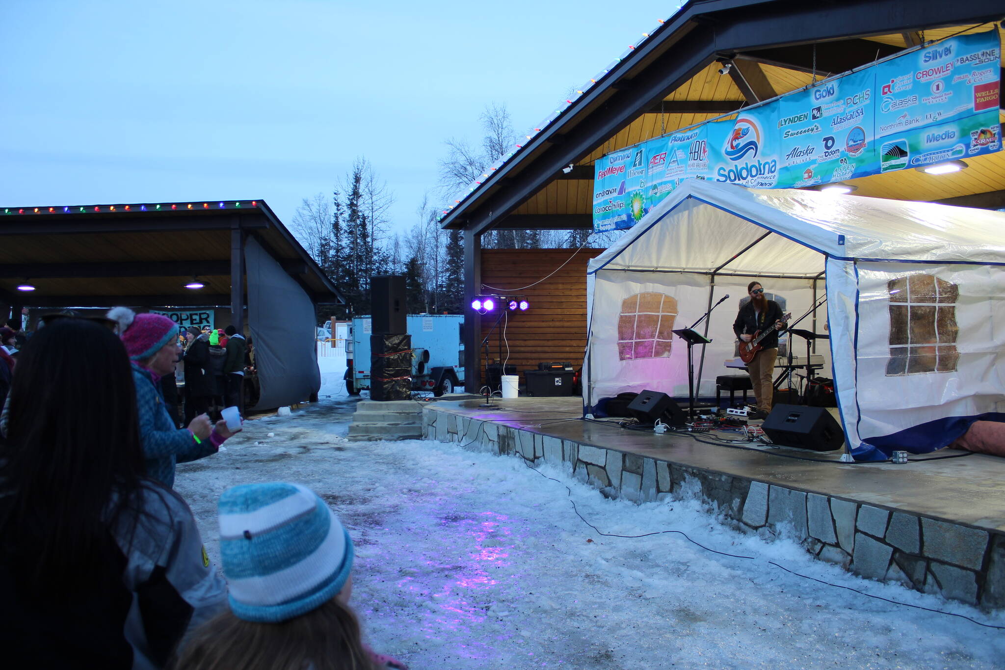 Patrons listen to live music during Frozen RiverFest on Saturday, Feb. 19, 2022, in Soldotna, Alaska. (Ashlyn O’Hara/Peninsula Clarion)