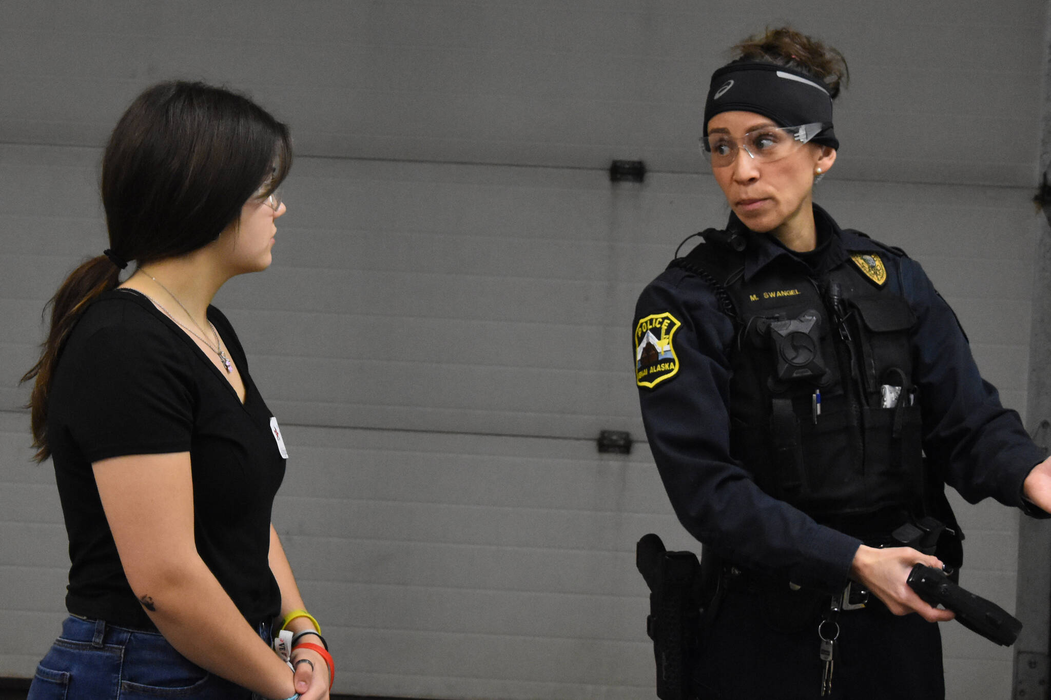 Kenai Central High School student Abby Castillo shadows Officer Megan Swangel at the Kenai Police Station in Kenai, Alaska, during Job Shadow Day on Wednesday, Feb. 15, 2023. (Cadance Bitterich/Peninsula Clarion)