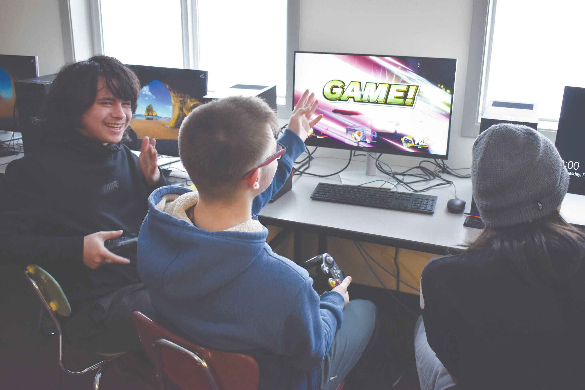 Jake Dye/Peninsula Clarion 
Eli Castro, Blake Gillis and Kaizen Fuller either celebrate victory or cry out in defeat at the end of a practice match of Super Smash Bros. Ultimate played ahead of a scheduled game at Kenai Central High School on Wednesday.