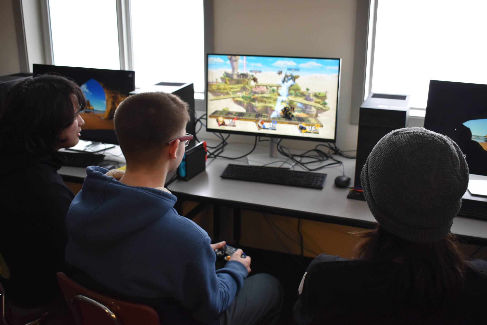 Eli Castro, Blake Gillis and Kaizen Fuller participate in a practice battle ahead of a scheduled game of Super Smash Bros. Ultimate at Kenai Central High School in Kenai, Alaska, on Wednesday, Feb. 15, 2023. (Jake Dye/Peninsula Clarion)
