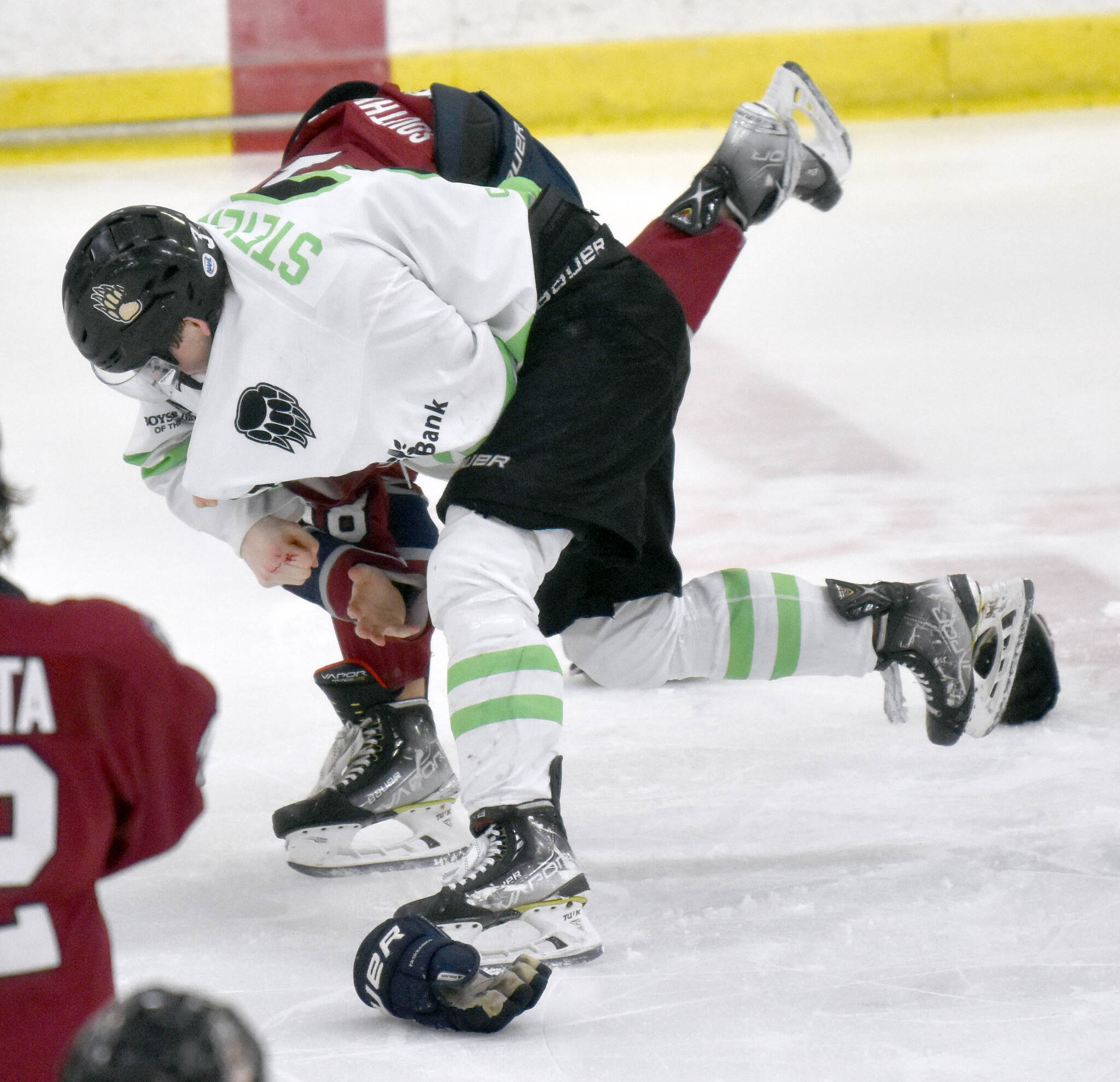 Nick Stevens of the Kenai River Brown Bears fights with Kole Altergott of the Fairbanks Ice Dogs on Saturday, Feb. 18, 2023, at the Soldotna Regional Sports Complex in Soldotna, Alaska. (Photo by Jeff Helminiak/Peninsula Clarion)