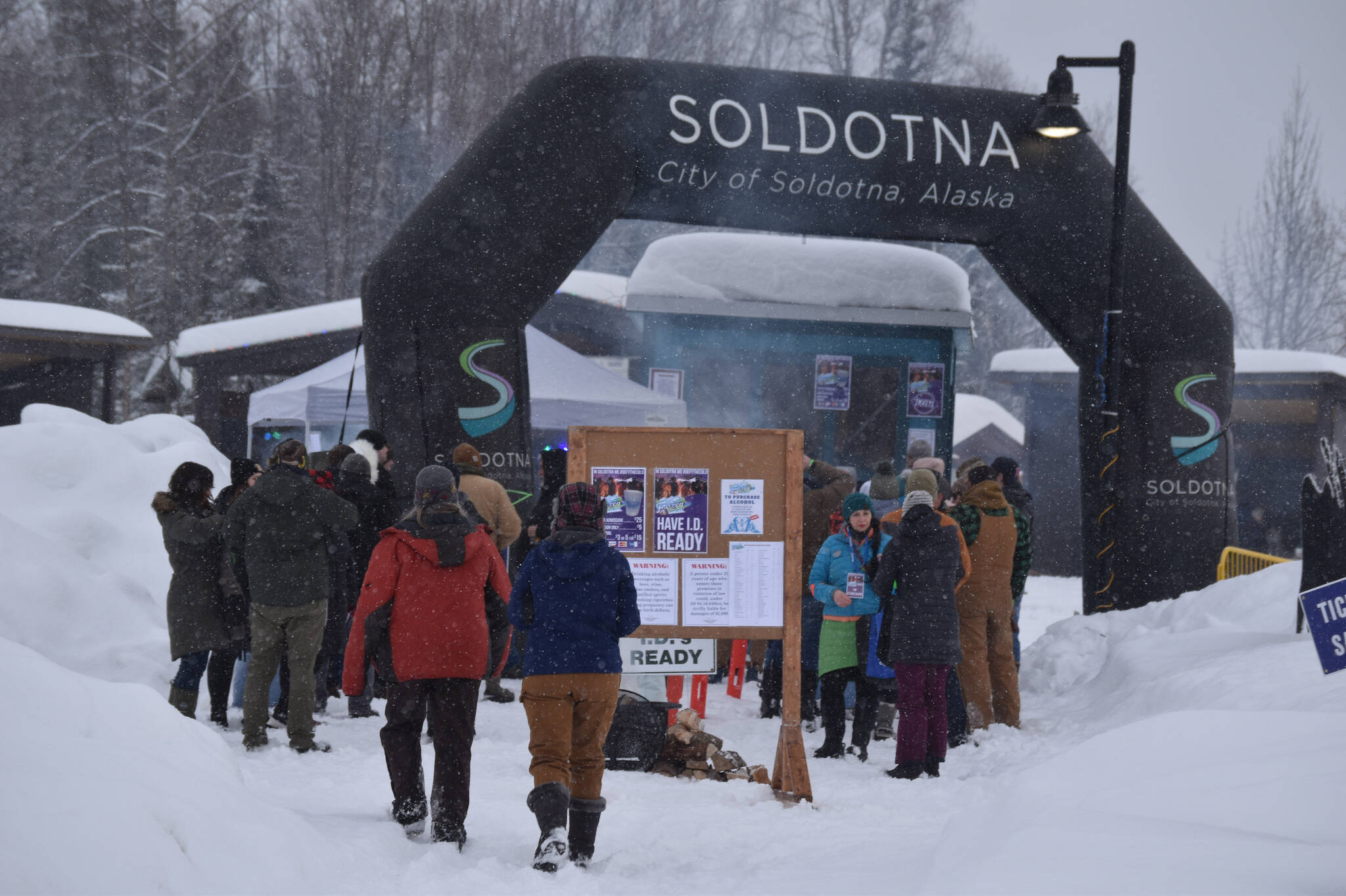 Attendees line up ahead of the start of Frozen RiverFest on Saturday, Feb. 18, 2023 at Soldotna Creek Park in Soldotna, Alaska. (Jake Dye/Peninsula Clarion)