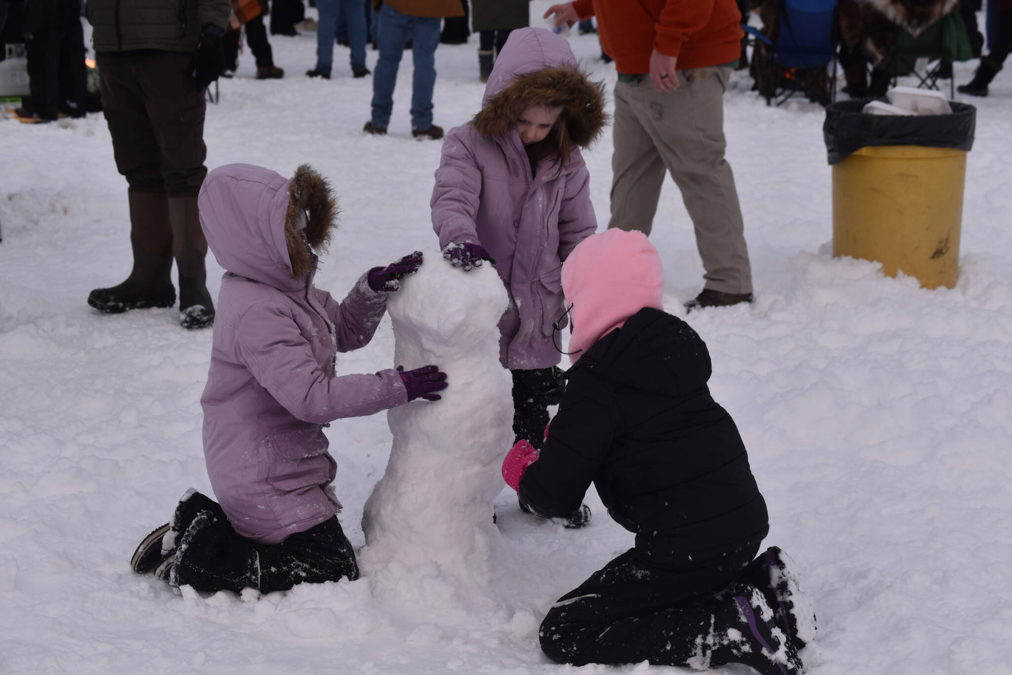 Children build snowmen during Frozen RiverFest on Saturday, Feb. 18, 2023 at Soldotna Creek Park in Soldotna, Alaska. (Jake Dye/Peninsula Clarion)