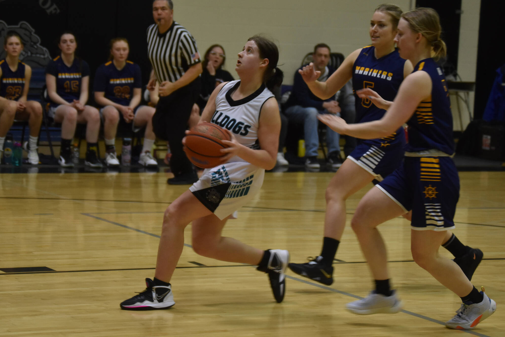 Nikiski's Ember Nelson looks to shoot, closely pursued by Homer's Minadora Reutov and Hannah Stonorov during a basketball game on Tuesday Feb. 21, 2023, at Nikiski Middle/High School in Nikiski, Alaska. (Jake Dye/Peninsula Clarion)