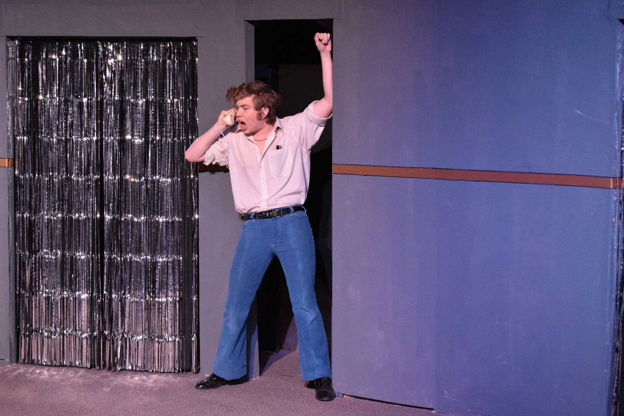 Josiah Burton portrays Chad during a rehersal of “Disaster!” on Tuesday, Feb. 21, 2023, at the Kenai Performers’ Theater in Soldotna, Alaska. (Jake Dye/Peninsula Clarion)