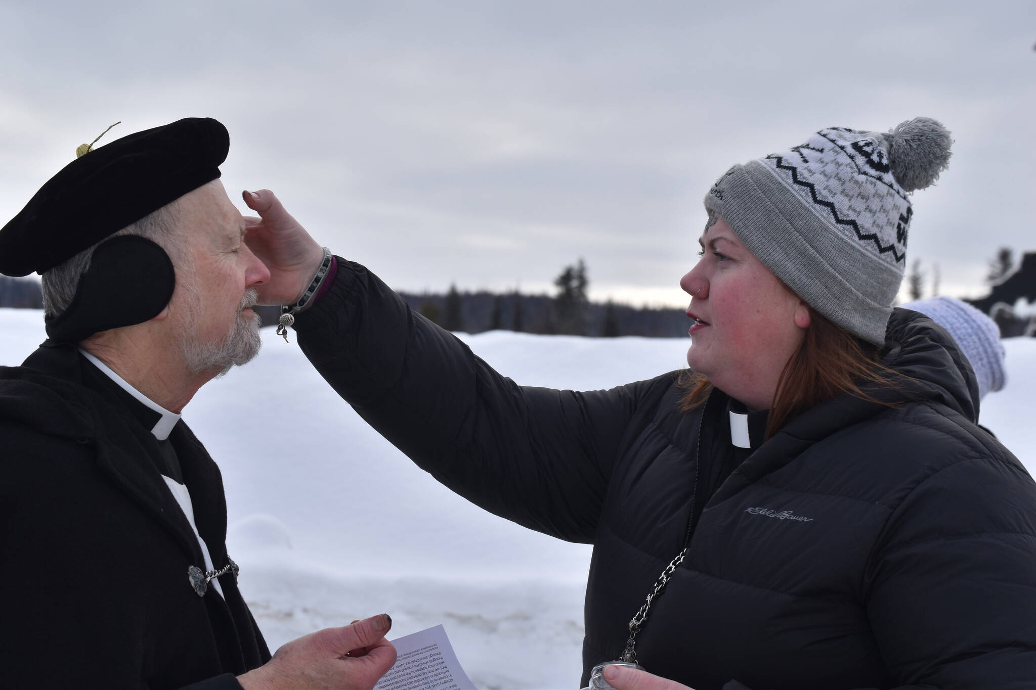 Father Rick Miles receives ashes from Pastor Meredith Harber as they prepare for Ashes to Go! on Wednesday; Feb. 22; 2023 at Soldotna Creek Park in Soldotna; Alaska. (Jake Dye/Peninsula Clarion)