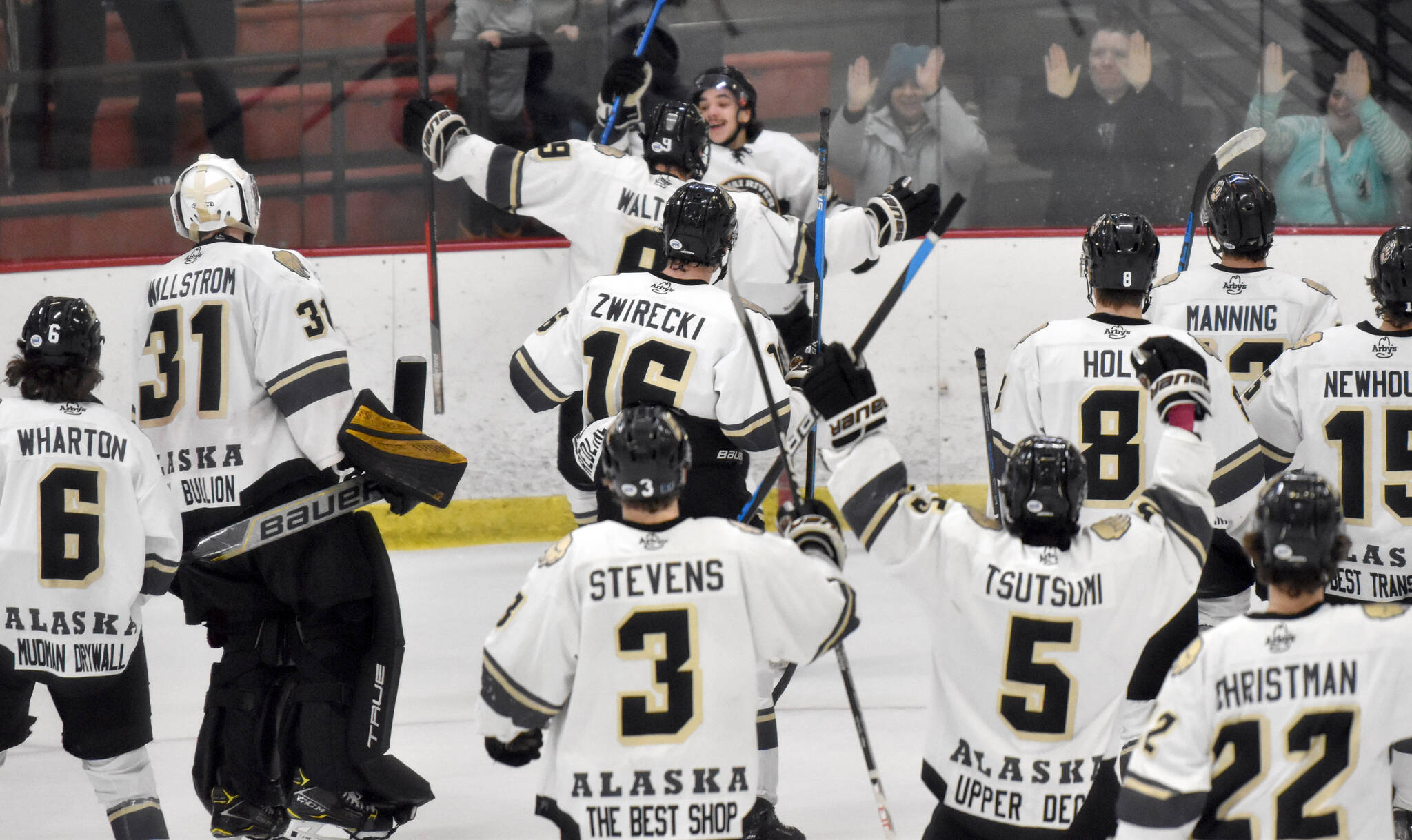The Kenai River Brown Bears mob Ryan Finch after he scored the game-winning goal in overtime against the Janesville (Wisconsin) Jets on Saturday, Feb. 25, 2023, at the Soldotna Regional Sports Complex in Soldotna, Alaska. (Photo by Jeff Helminiak/Peninsula Clarion)