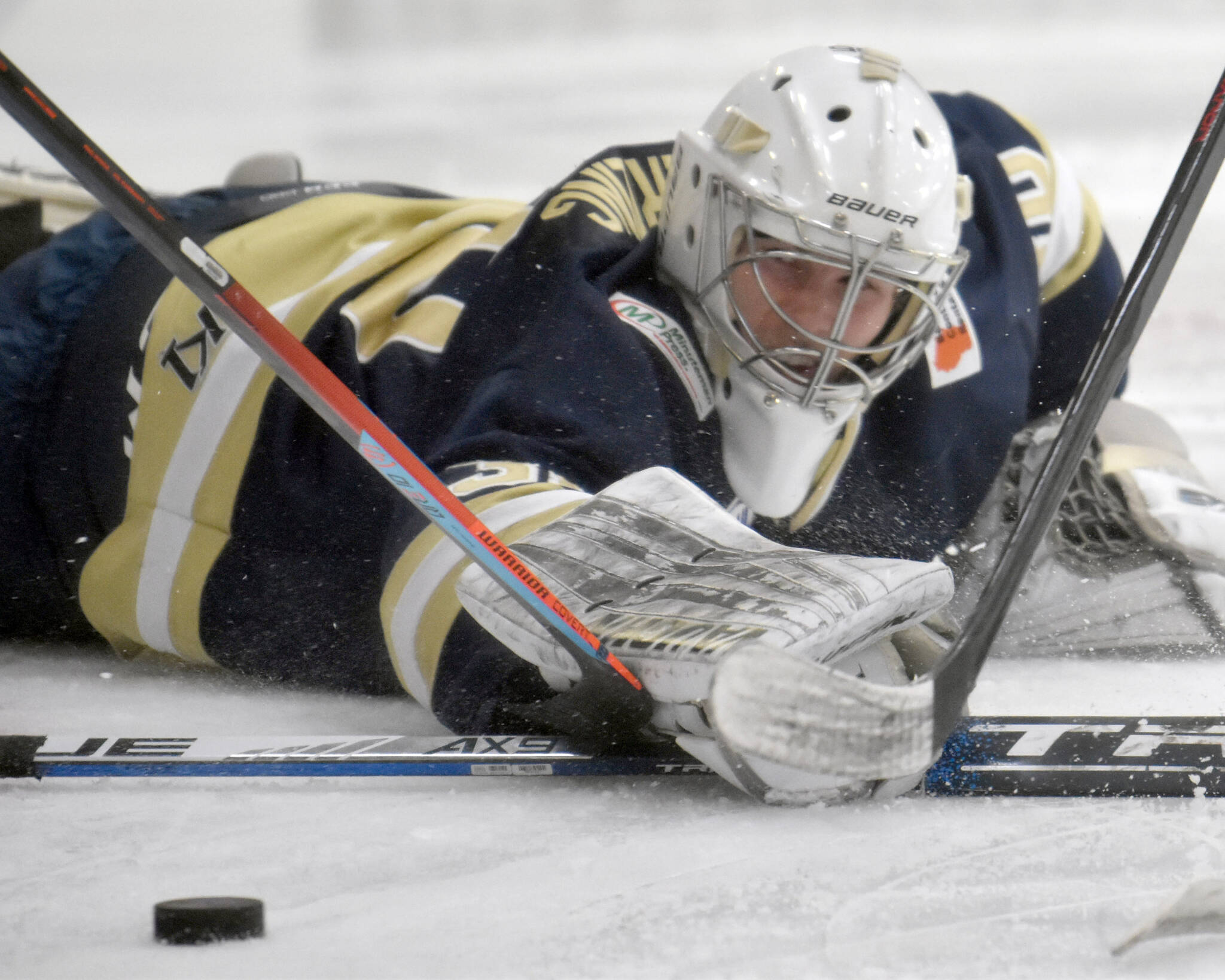 Janesville (Wisconsin) Jets goalie Peter Sterling tries to corral the puck Saturday, Feb. 25, 2023, at the Soldotna Regiona Sports Complex in Soldotna, Alaska. (Photo by Jeff Helminiak/Peninsula Clarion)
