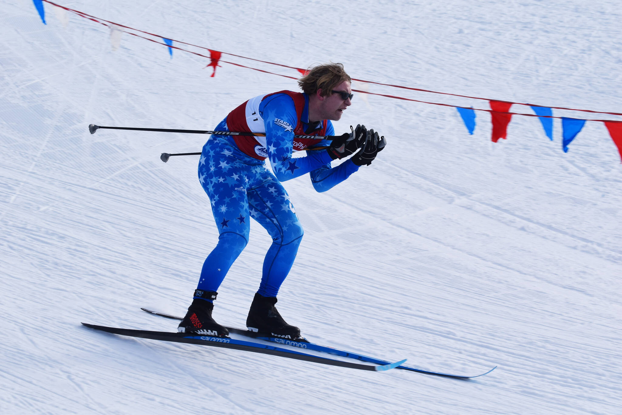 Soldotna’s Andrew Cox tucks for a downhill during the first leg of the boys 4x5-kilometer relay at the ASAA State Nordic Ski Championships at Kincaid Park in Anchorage, Alaska, on Saturday, Feb. 25, 2023. (Jake Dye/Peninsula Clarion)