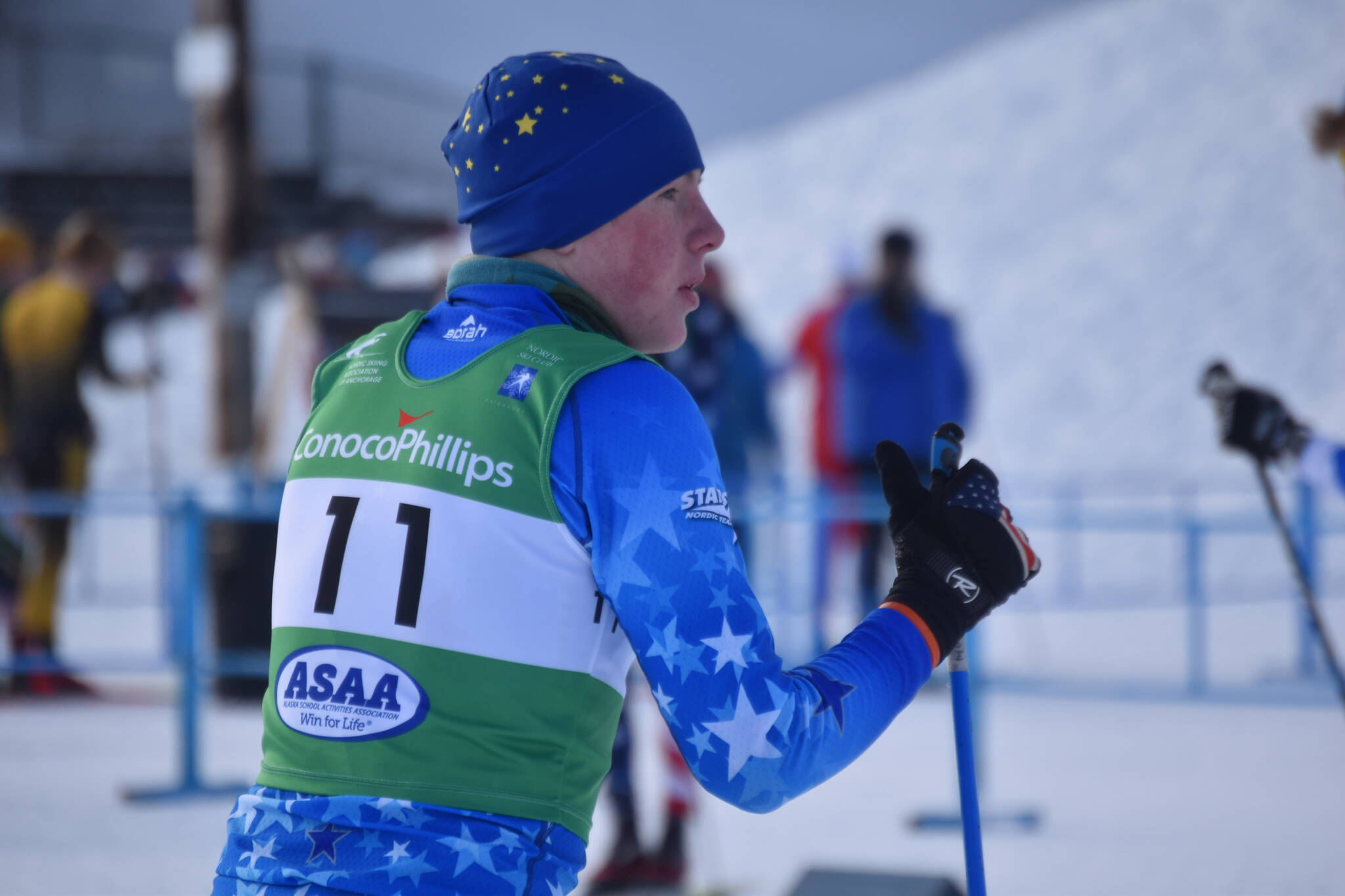 Bennjamin Abel, of Soldotna, waits for his teammate to tag him into the second leg of the boys 4x5-kilometer relay at the ASAA State Nordic Ski Championships at Kincaid Park in Anchorage, Alaska, on Saturday, Feb. 25, 2023. (Jake Dye/Peninsula Clarion)
