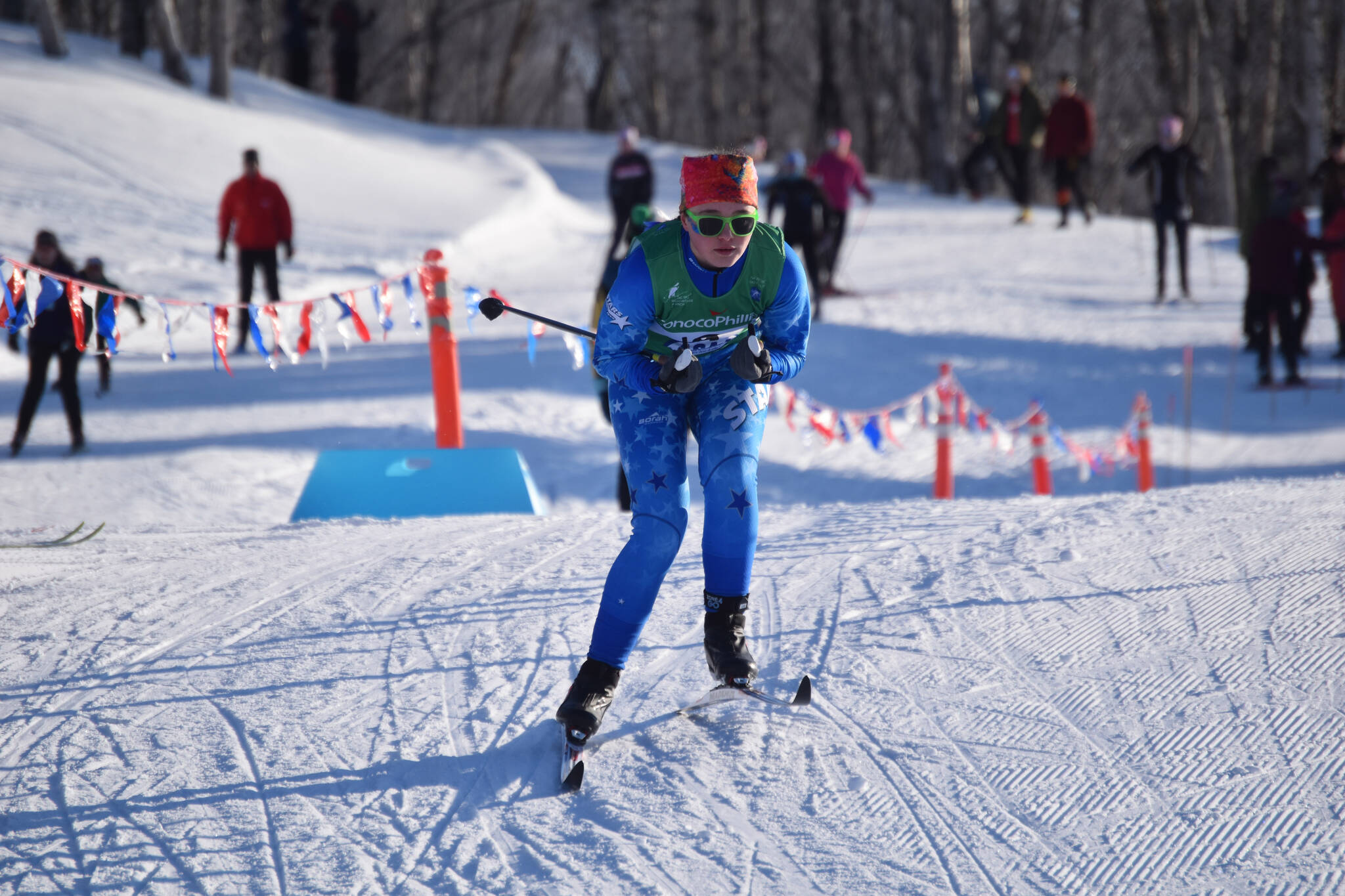 Ariana Cannava, of Soldotna, tucks for a downhill during the girls 4x3.5-kilometer relay at the ASAA State Nordic Ski Championships at Kincaid Park in Anchorage, Alaska, on Saturday, Feb. 25, 2023. (Jake Dye/Peninsula Clarion)