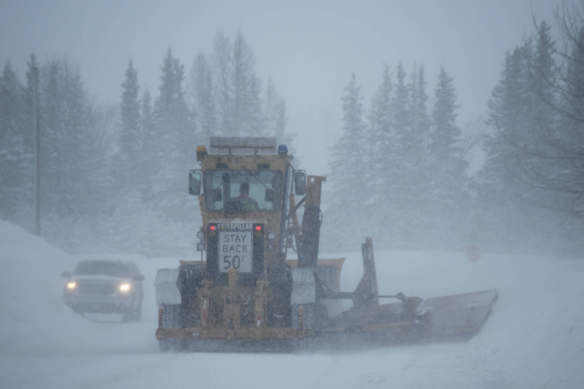 A grader moves down First Avenue in Kenai, Alaska, during a snow storm on Tuesday, Feb. 28, 2023. (Jake Dye/Peninsula Clarion)