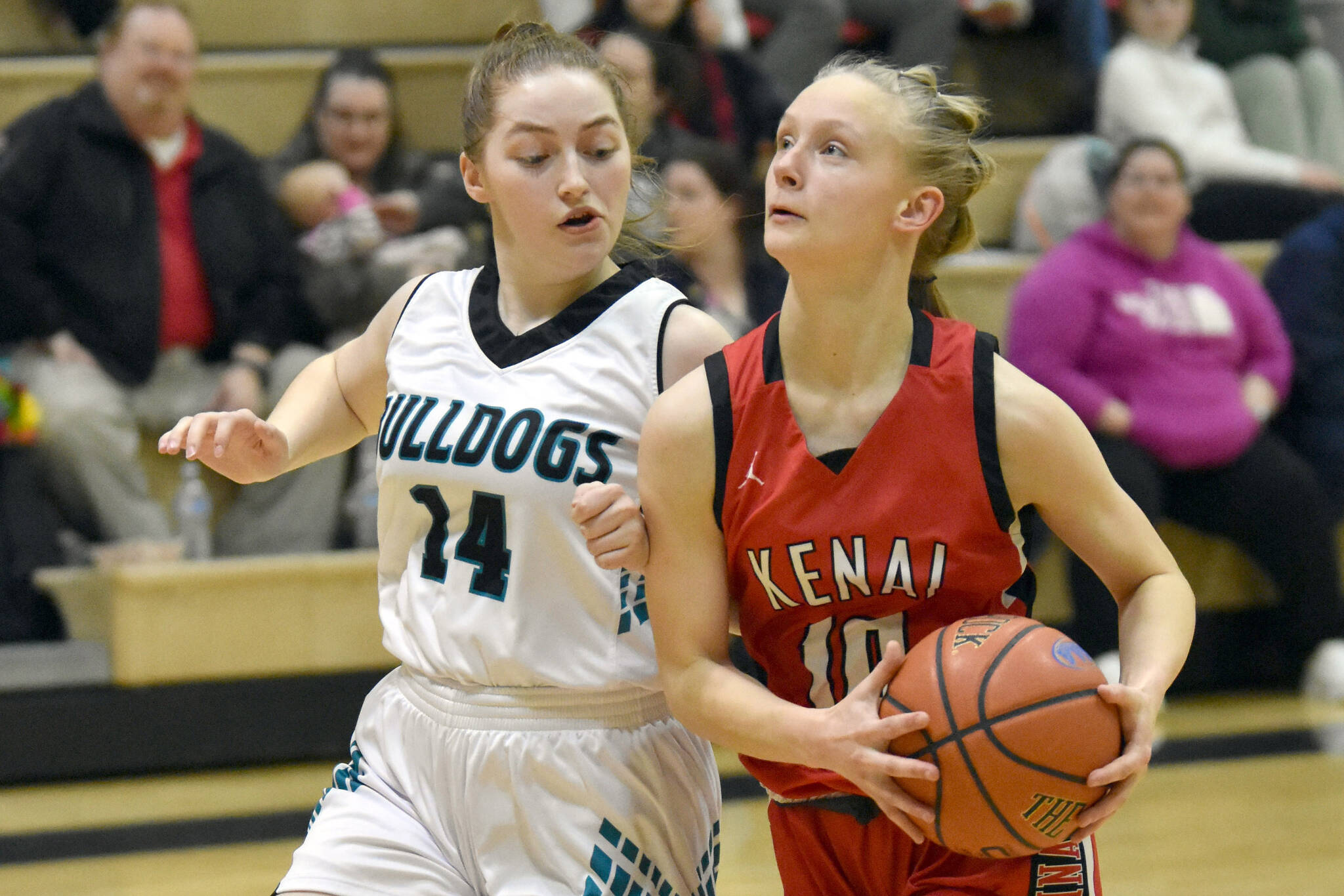 Nikiski's Avery Ellis defends Kenai Central's Rylie Sparks on Tuesday, Feb. 28, 2023, at Nikiski Middle-High School in Nikiski, Alaska. (Photo by Jeff Helminiak/Peninsula Clarion)