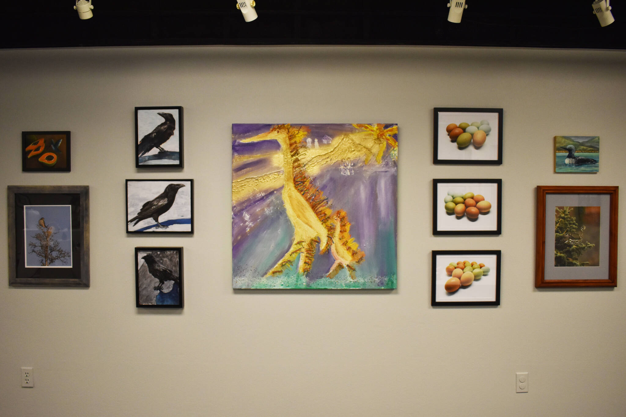 An array of artwork depicting birds hangs in the Kenai Art Center in Kenai, Alaska on Feb. 28, 2023, part of “Bird Call,” the center’s March show. (Jake Dye/Peninsula Clarion)
