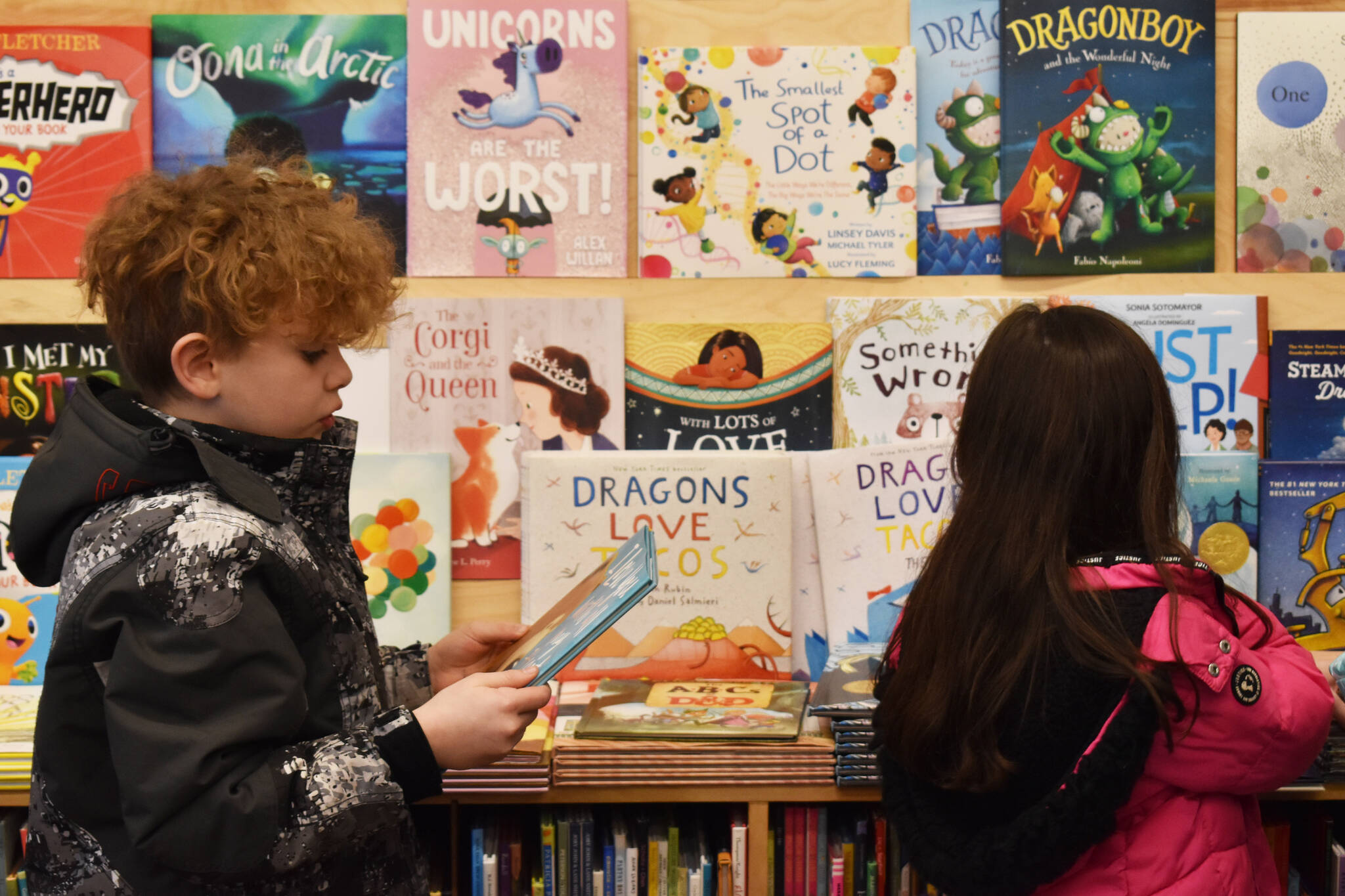 Soldotna Elementary students select books on Wednesday, March 8, 2023, at River City Books in Soldotna, Alaska. (Jake Dye/Peninsula Clarion)