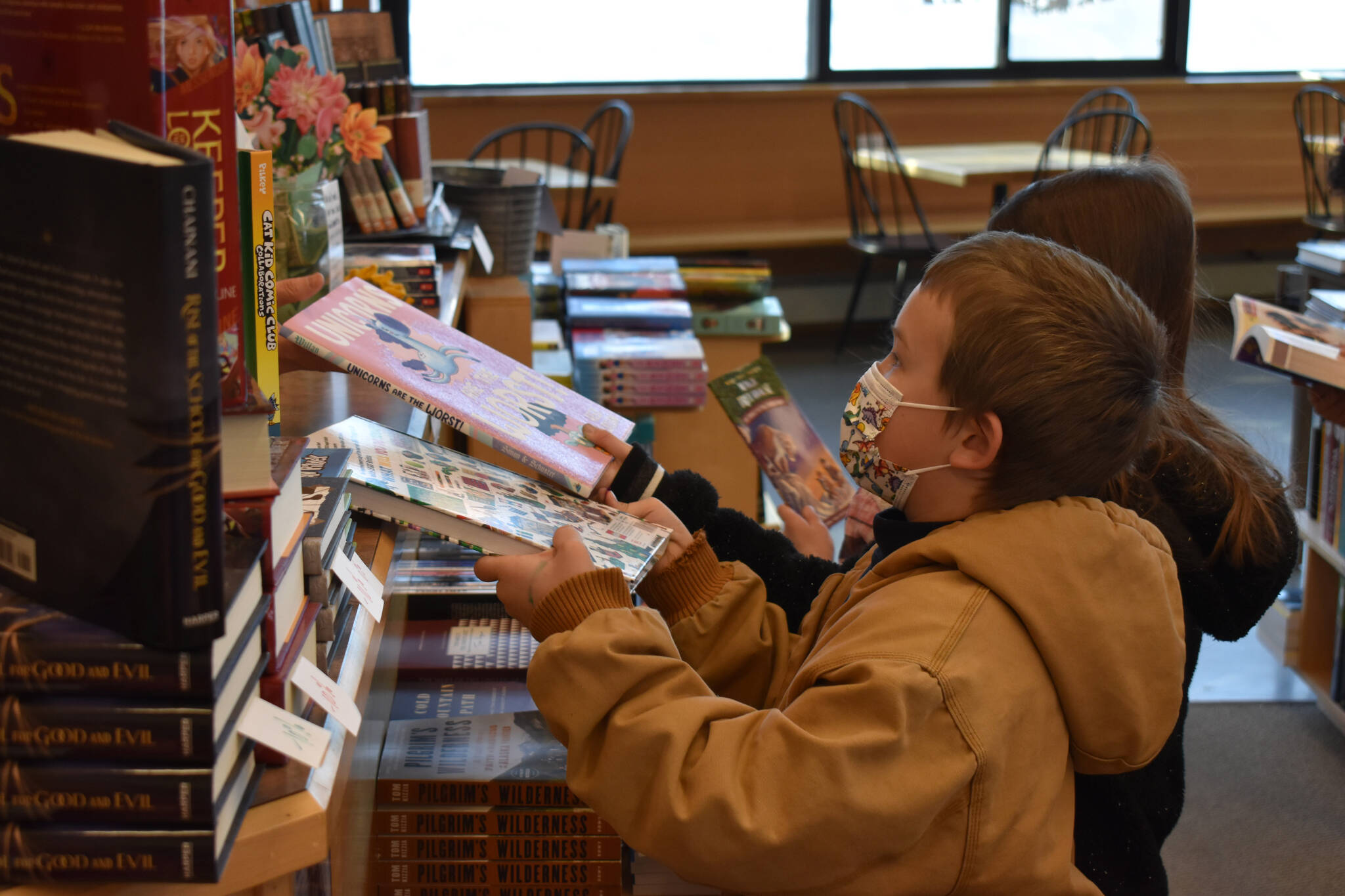 Soldotna Elementary students check out with their books on Wednesday, March 8, 2023, at River City Books in Soldotna, Alaska. (Jake Dye/Peninsula Clarion)