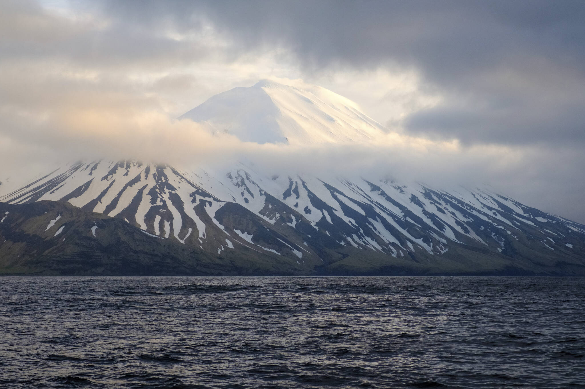 In this photo provided by the Alaska Volcano Observatory/U.S. Geological Survey is the Tanaga Volcano near Adak, Alaska, on May 23, 2021. A swarm of earthquakes occurring over the past few weeks has intensified at a remote Alaska volcano dormant for over a century, a possible indication of an impending eruption. The Alaska Volcano Observatory raised the alert level to advisory status for Tanaga Volcano late Tuesday, March 7, 2023, after the quakes became very vigorous. (Matt Loewen/Alaska Volcano Observatory/U.S. Geological Survey via AP)