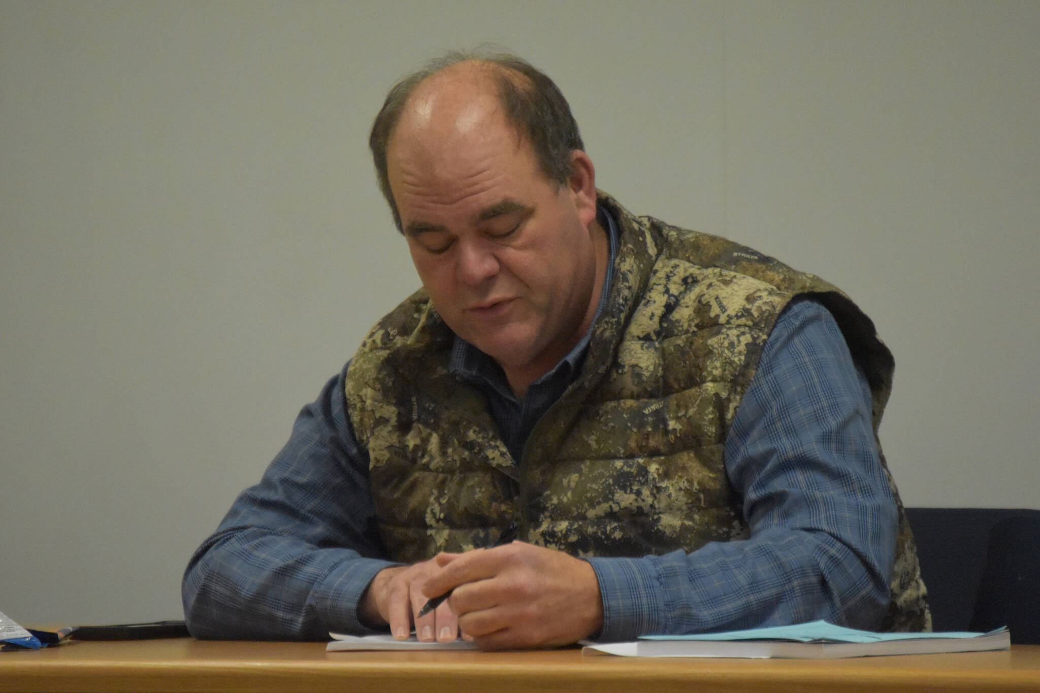 Mike Crawford, Chair of the Kenai/Soldotna Fish and Game Advisory Committee, writes the language of an amendment to Board of Game Proposal 105, passed unanimously by the committee during a meeting on Monday, Jan. 23, 2023, at the Cook Inlet Aquaculture Association in Kenai, Alaska. (Jake Dye/Peninsula Clarion)