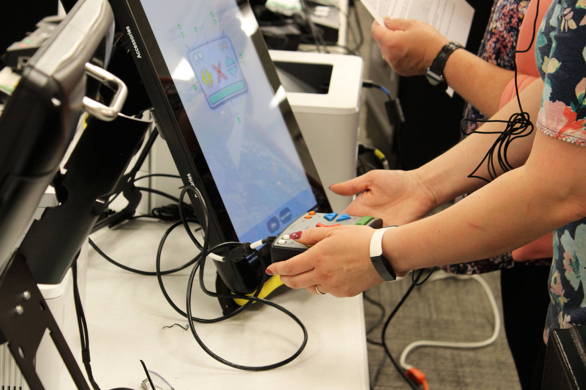 Rachel Nash tests voting equipment at the George A. Navarre Borough building on Thursday, Sept. 9, 2021, in Soldotna, Alaska. (Ashlyn O’Hara/Peninsula Clarion)