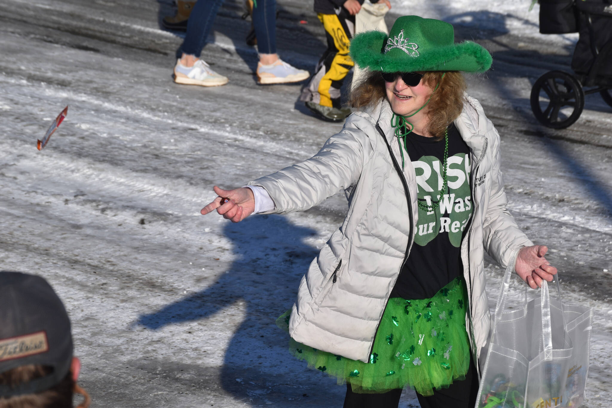 Candy is thrown as the 32nd annual Sweeney’s St. Patrick’s Day Parade proceeds down Fireweed Street in Soldotna, Alaska on Friday, March 17, 2023. (Jake Dye/Peninsula Clarion)