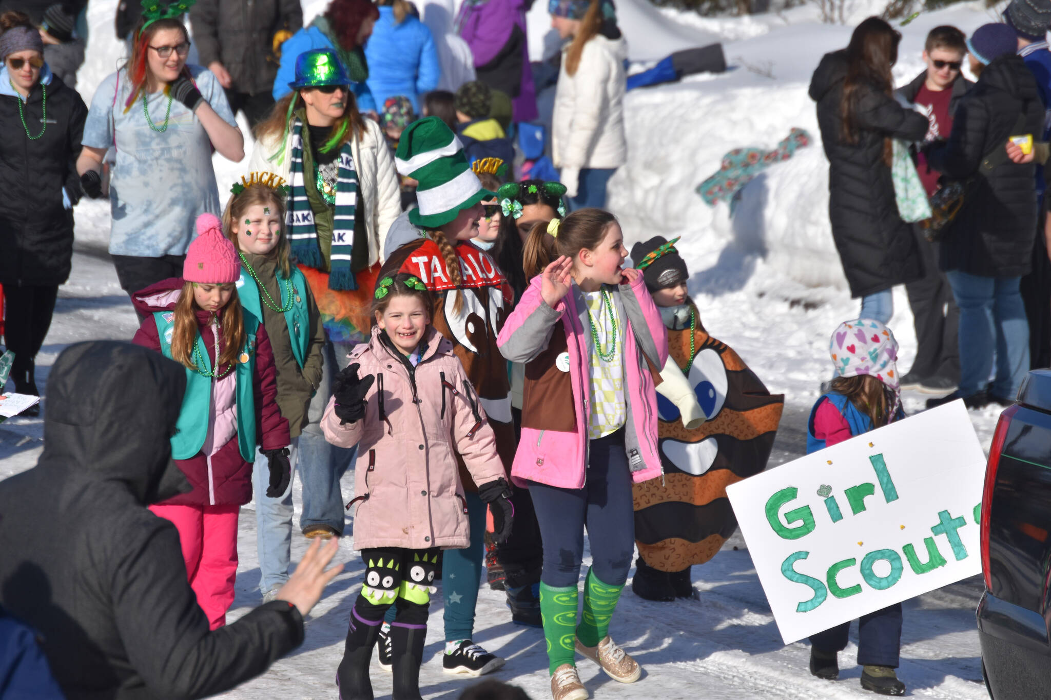 Children walk and wave as the 32nd annual Sweeney’s St. Patrick’s Day Parade proceeds down Fireweed Street in Soldotna, Alaska on Friday, March 17, 2023. (Jake Dye/Peninsula Clarion)