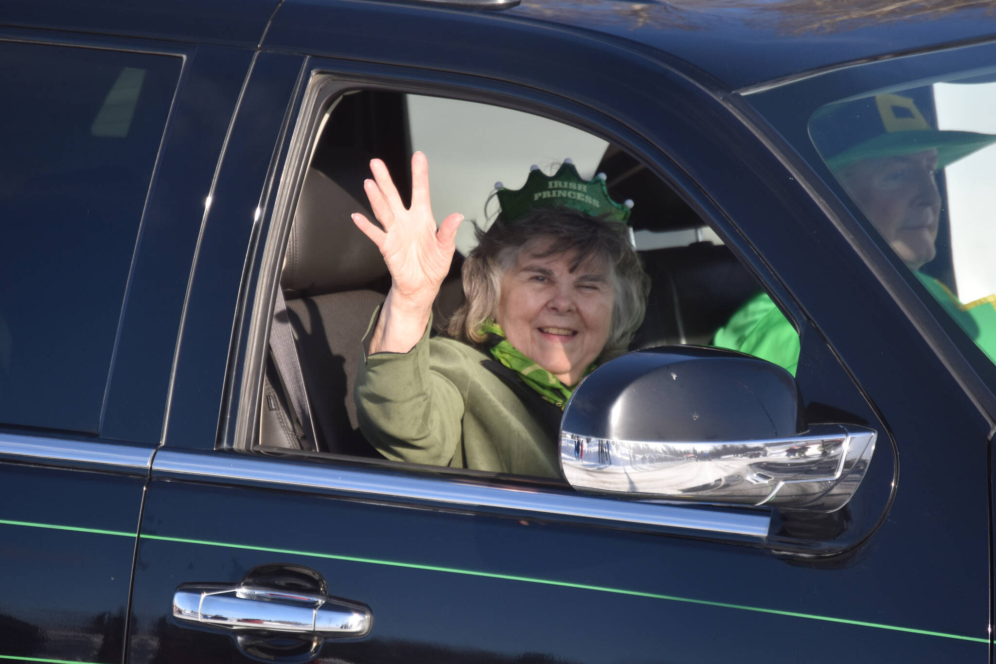 Gloria Sweeney and Mike Sweeney ride and wave as the 32nd annual Sweeney’s St. Patrick’s Day Parade proceeds down Fireweed Street in Soldotna, Alaska on Friday, March 17, 2023. (Jake Dye/Peninsula Clarion)