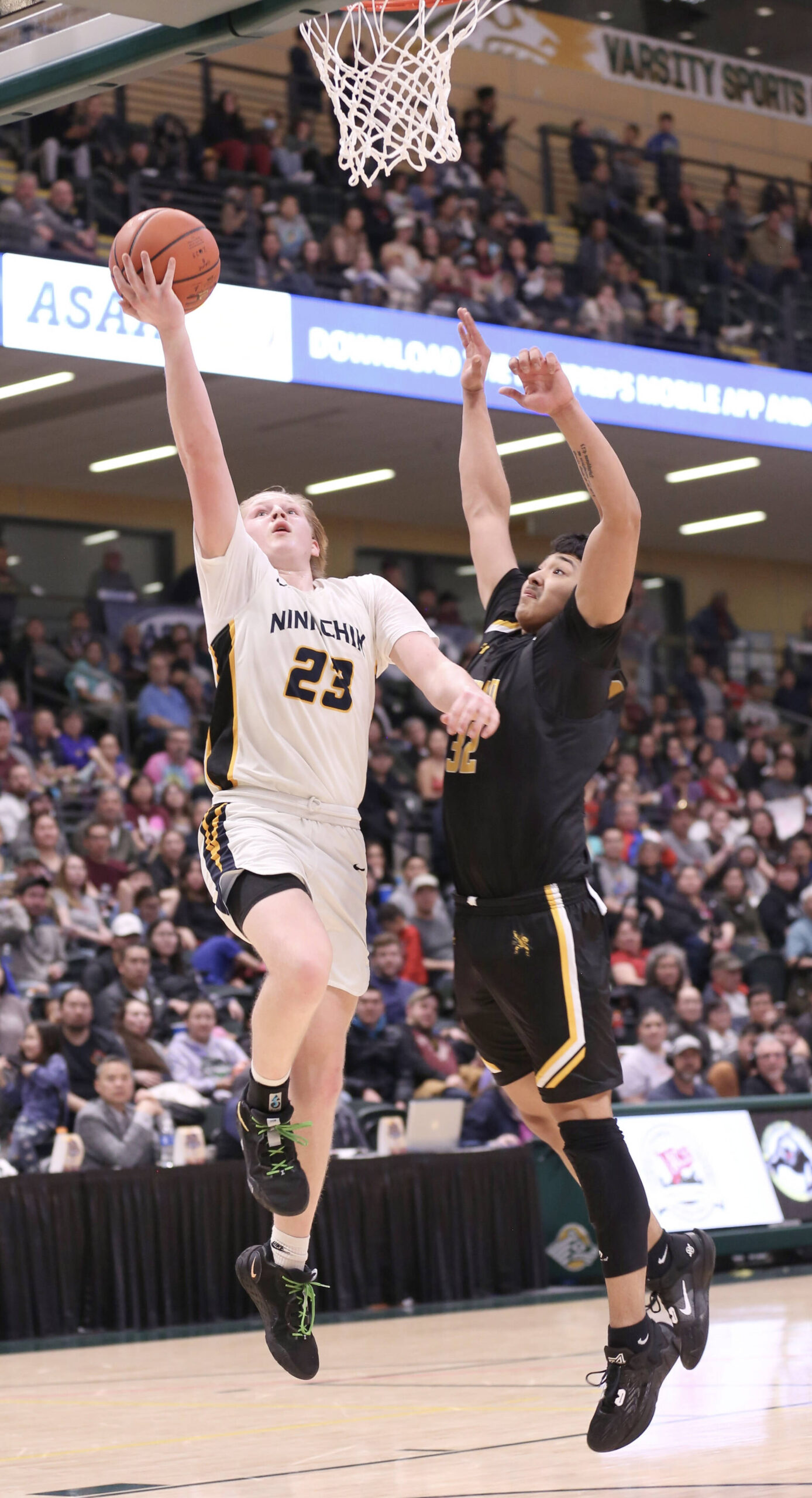 Ninilchik’s Cole Moore drives against Tikigaq’s Midas Tuzroyluk during the Class 2A boys state championship Saturday, March 18, 2023, at the Alaska Airlines Center in Anchorage, Alaska. (Photo courtesy of Robin Moore)