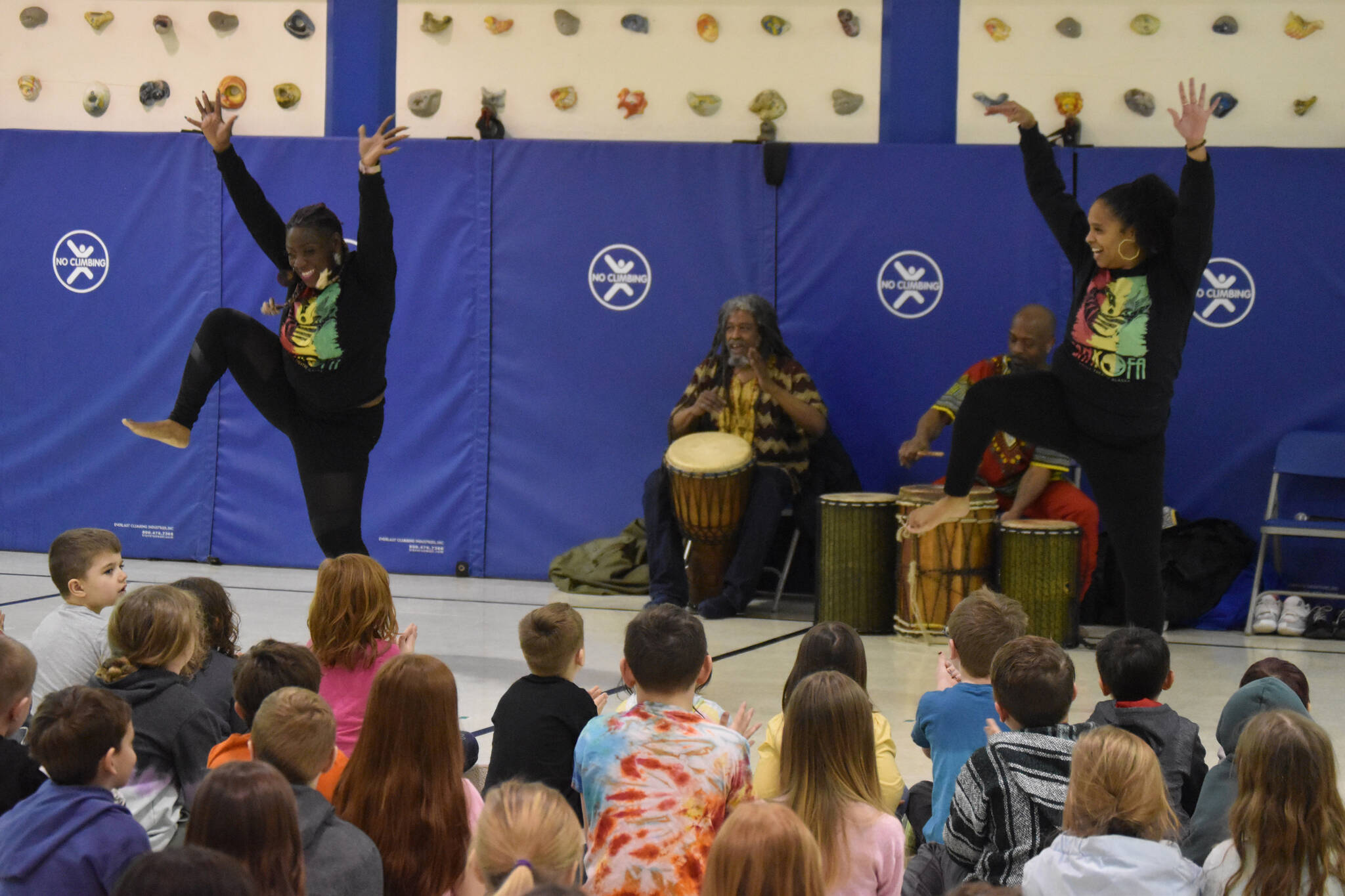 The members of Sankofa Dance Theater Alaska perform for a crowd of students during an opening performance at Kaleidoscope School of Arts and Science in Kenai, Alaska on Monday, March 20, 2023. (Jake Dye/Peninsula Clarion)