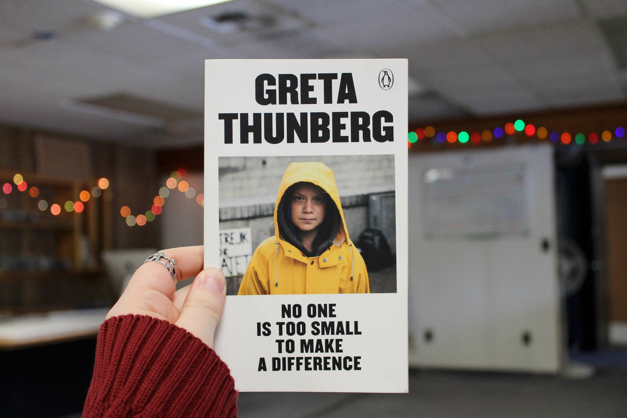 The author holds a copy of Greta Thunberg’s, “No One Is Too Small to Make a Difference,” inside the Peninsula Clarion building on Wednesday, March 22, 2023, in Kenai, Alaska. (Ashlyn O’Hara/Peninsula Clarion)