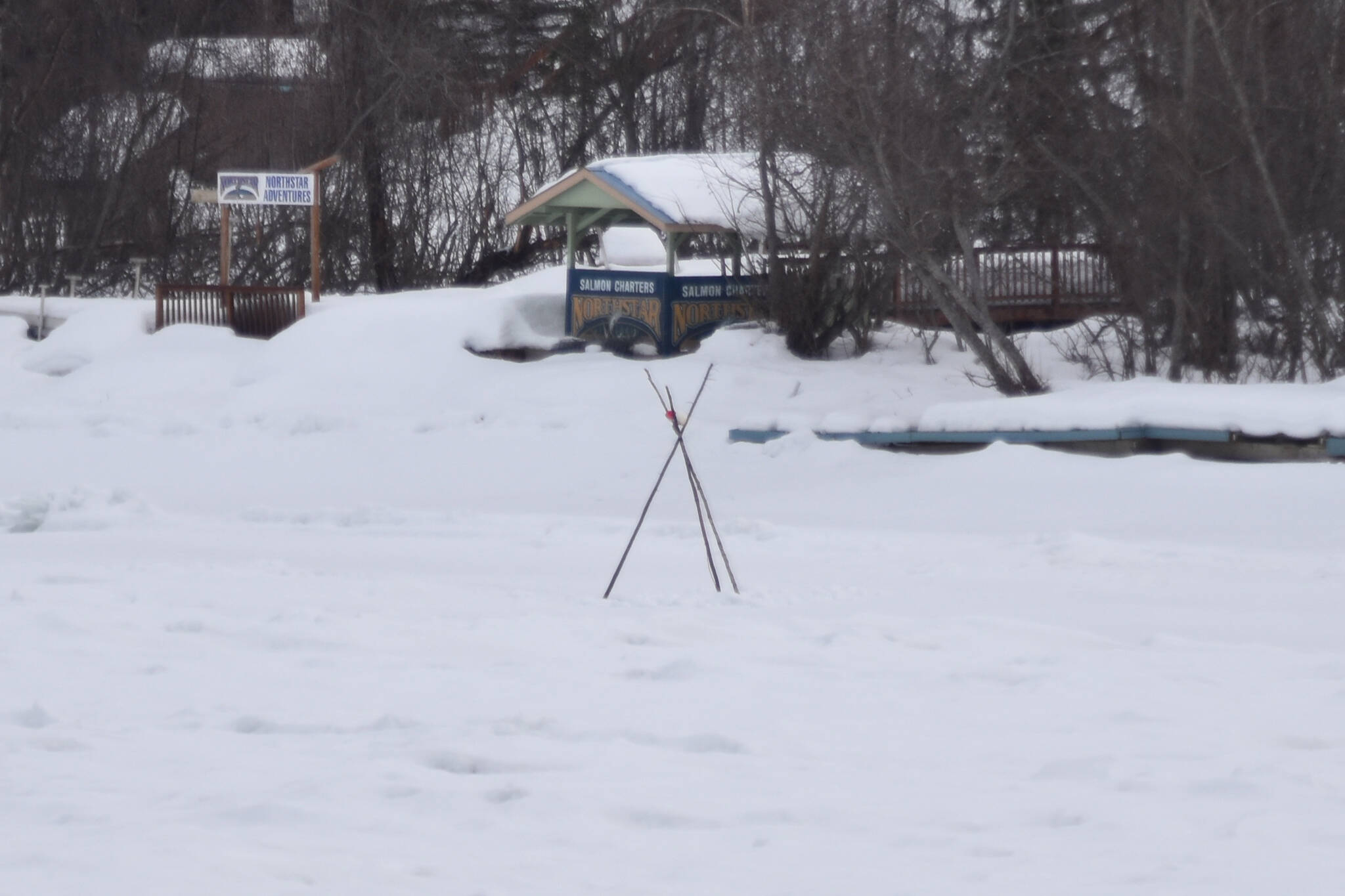 A tripod set by the Soldotna and Kenai Rotary Clubs stands over the ice of the Kenai River in Soldotna, Alaska on Tuesday, March 28, 2023. (Jake Dye/Peninsula Clarion)