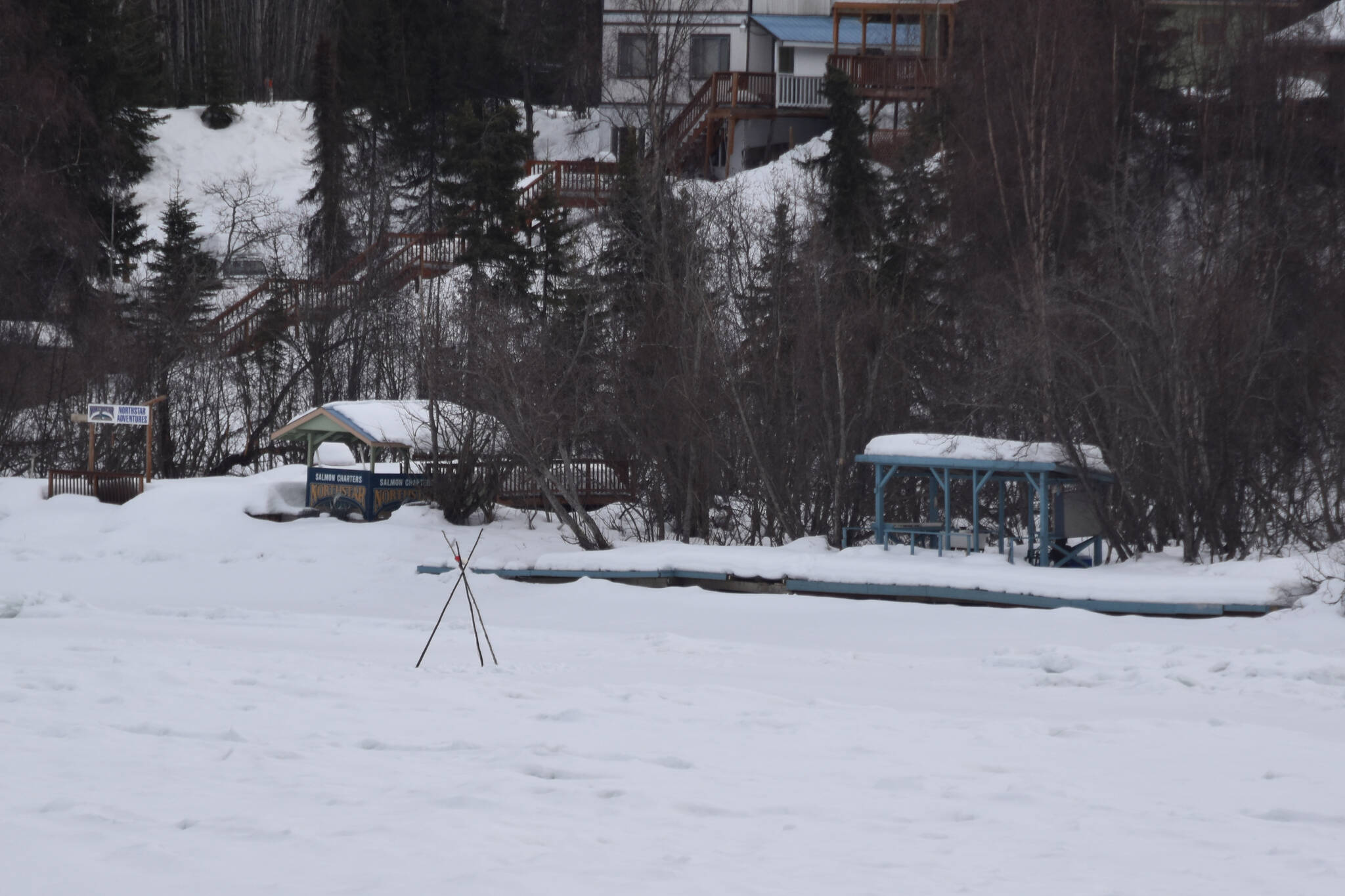 A tripod set by the Soldotna and Kenai Rotary Clubs stands over the ice of the Kenai River in Soldotna, Alaska on Tuesday, March 28, 2023. (Jake Dye/Peninsula Clarion)