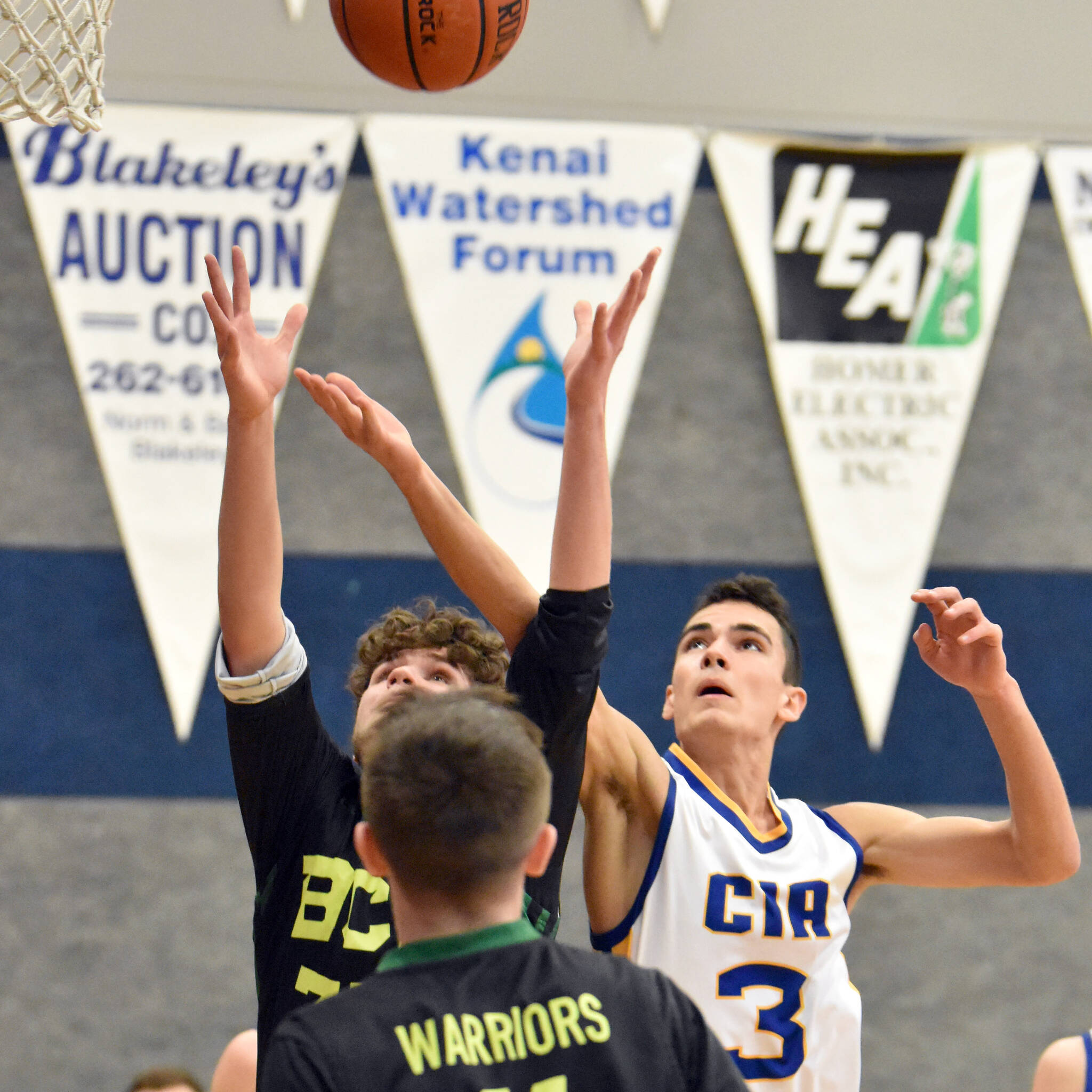 Cook Inlet Academy sophomore Ian McGarry battles for a rebound against Birchwood Christian on Saturday, Jan. 21, 2023, at Cook Inlet Academy just outside of Soldotna, Alaska. (Photo by Jeff Helminiak/Peninsula Clarion)