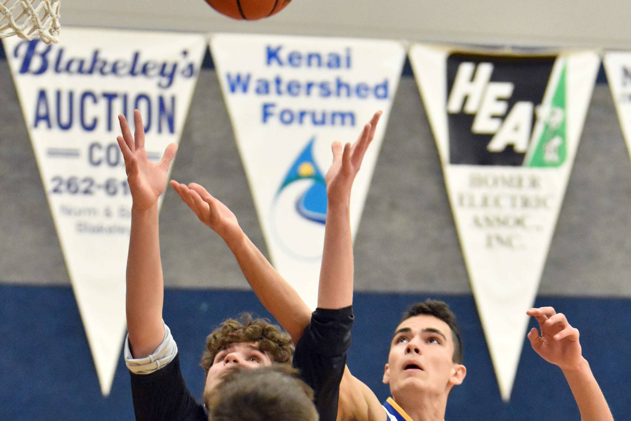 Cook Inlet Academy junior Ian McGarry battles for a rebound against Birchwood Christian on Saturday, Jan. 21, 2023, at Cook Inlet Academy just outside of Soldotna, Alaska. (Photo by Jeff Helminiak/Peninsula Clarion)