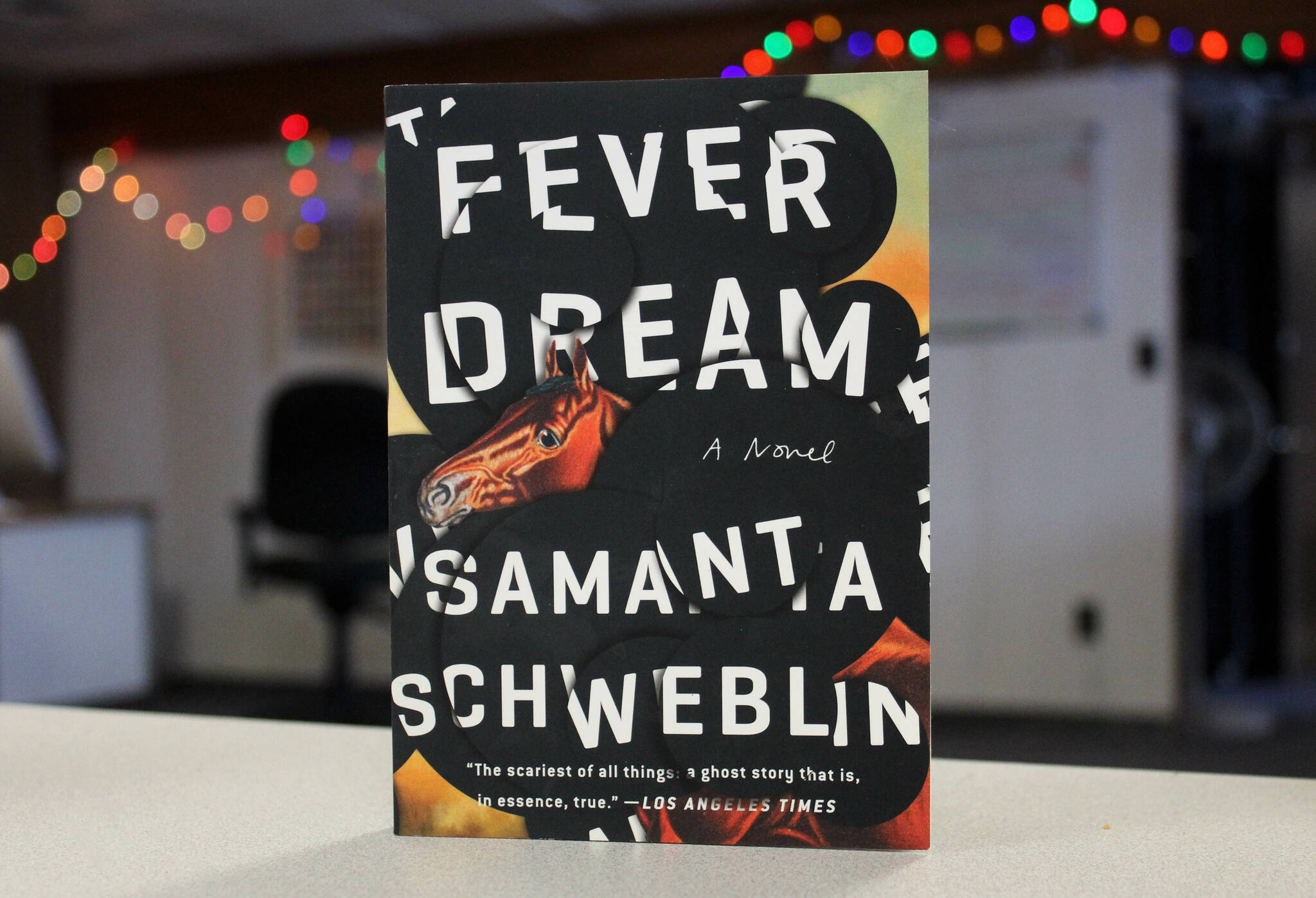 A copy of Samanta Schweblin’s “Fever Dream” sits on a desk in the Peninsula Clarion building on Thursday, March 30, 2023, in Kenai, Alaska. (Ashlyn O’Hara/Peninsula Clarion)