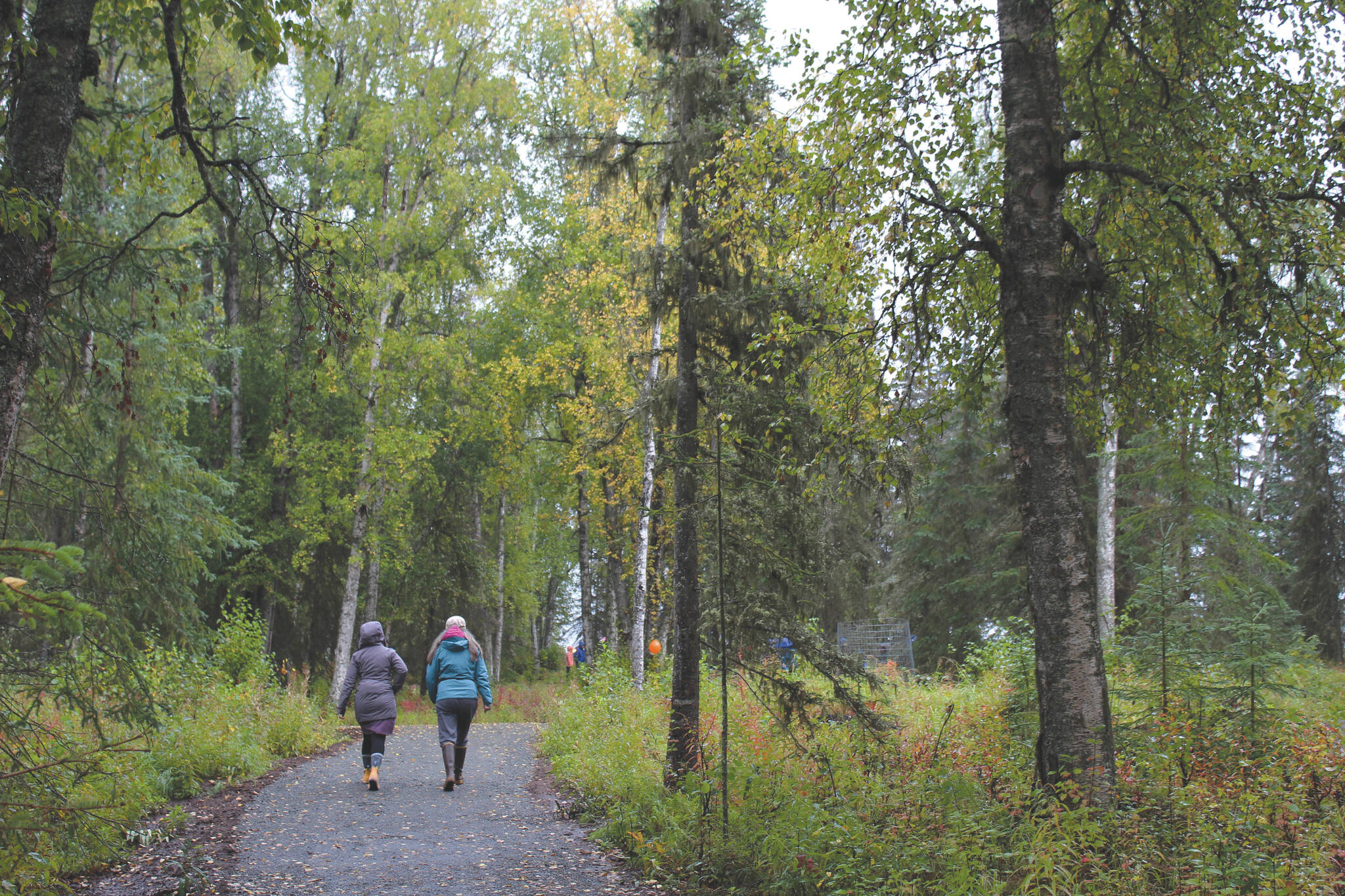 Ashlyn O’Hara / Peninsula Clarion 
Visitors walk toward the grand opening and dedication ceremony for the Kenai Peninsula Peace Crane Garden Trails near Soldotna on Sept. 8.