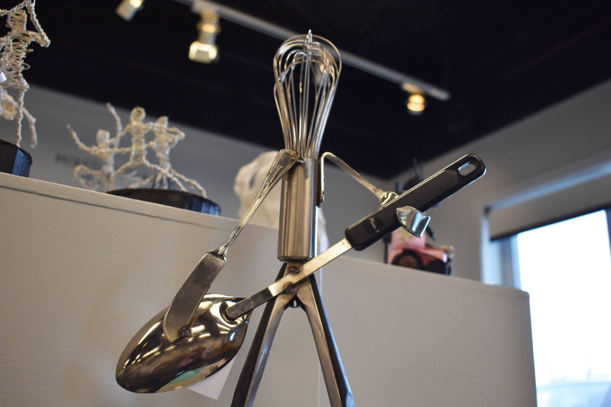 A sculpture of a guitarist is made entirely from kitchen utensils, standing on a plinth at the Kenai Art Center in Kenai, Alaska on Wednesday, April 5, 2023, in preparation for the debut of the 32nd Annual Kenai Peninsula Borough School District Visual Feast. (Jake Dye/Peninsula Clarion)