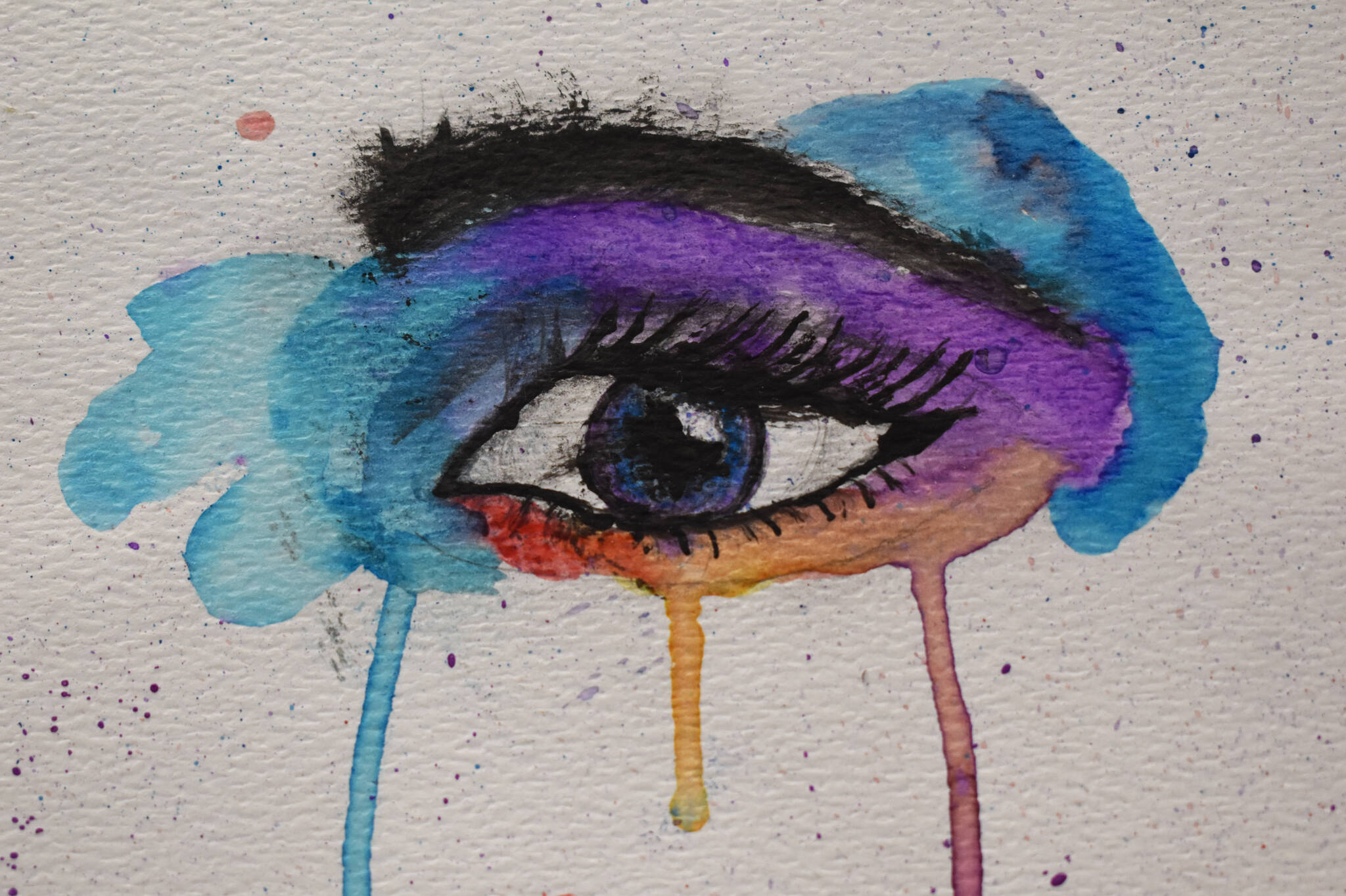 A colorful painting of an eye hangs at the Kenai Art Center in Kenai, Alaska on Wednesday, April 5, 2023, in preparation for the debut of the 32nd Annual Kenai Peninsula Borough School District Visual Feast. (Jake Dye/Peninsula Clarion)