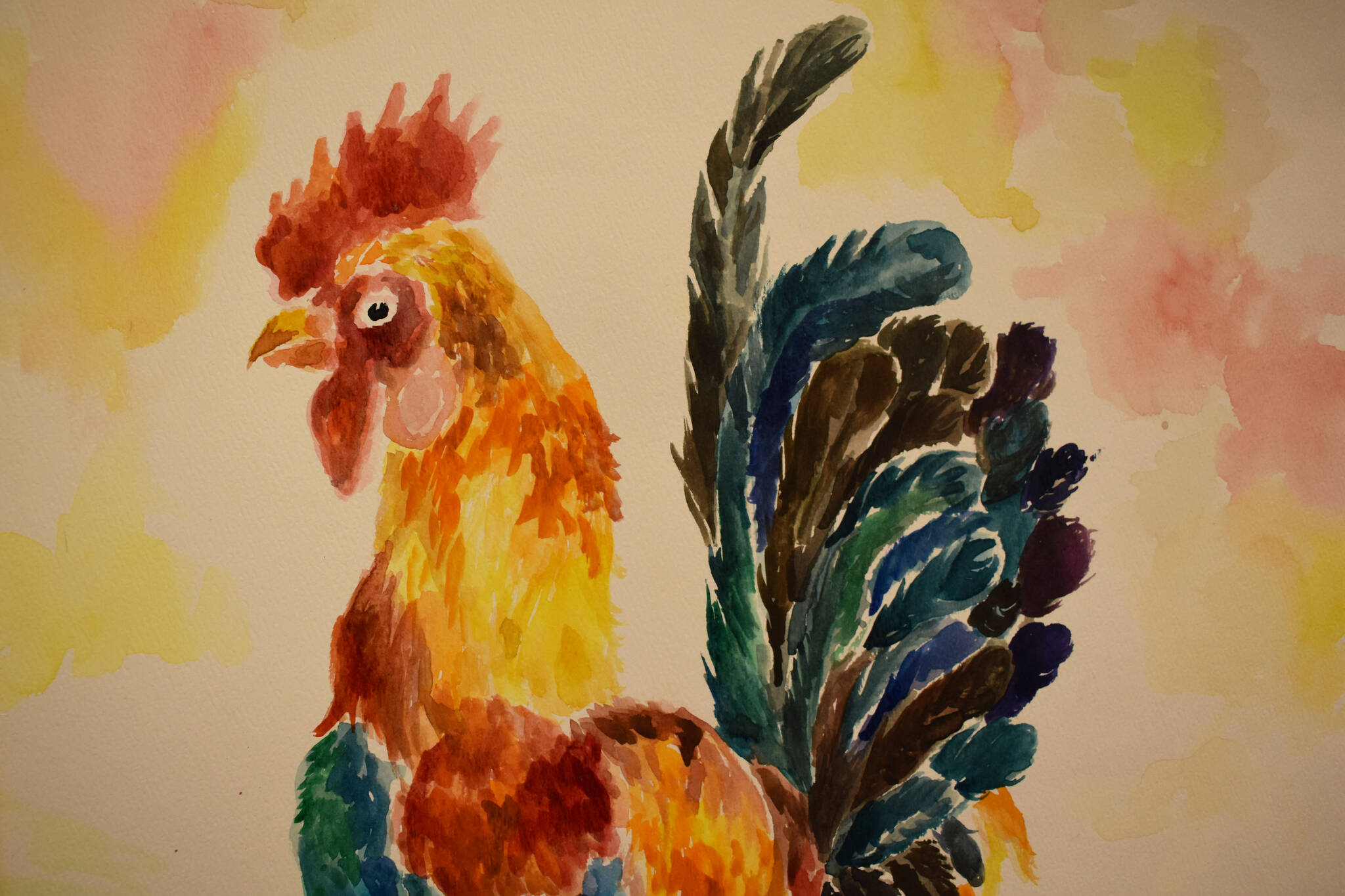 A colorful painting of a rooster hangs at the Kenai Art Center in Kenai, Alaska on Wednesday, April 5, 2023, in preparation for the debut of the 32nd Annual Kenai Peninsula Borough School District Visual Feast. (Jake Dye/Peninsula Clarion)