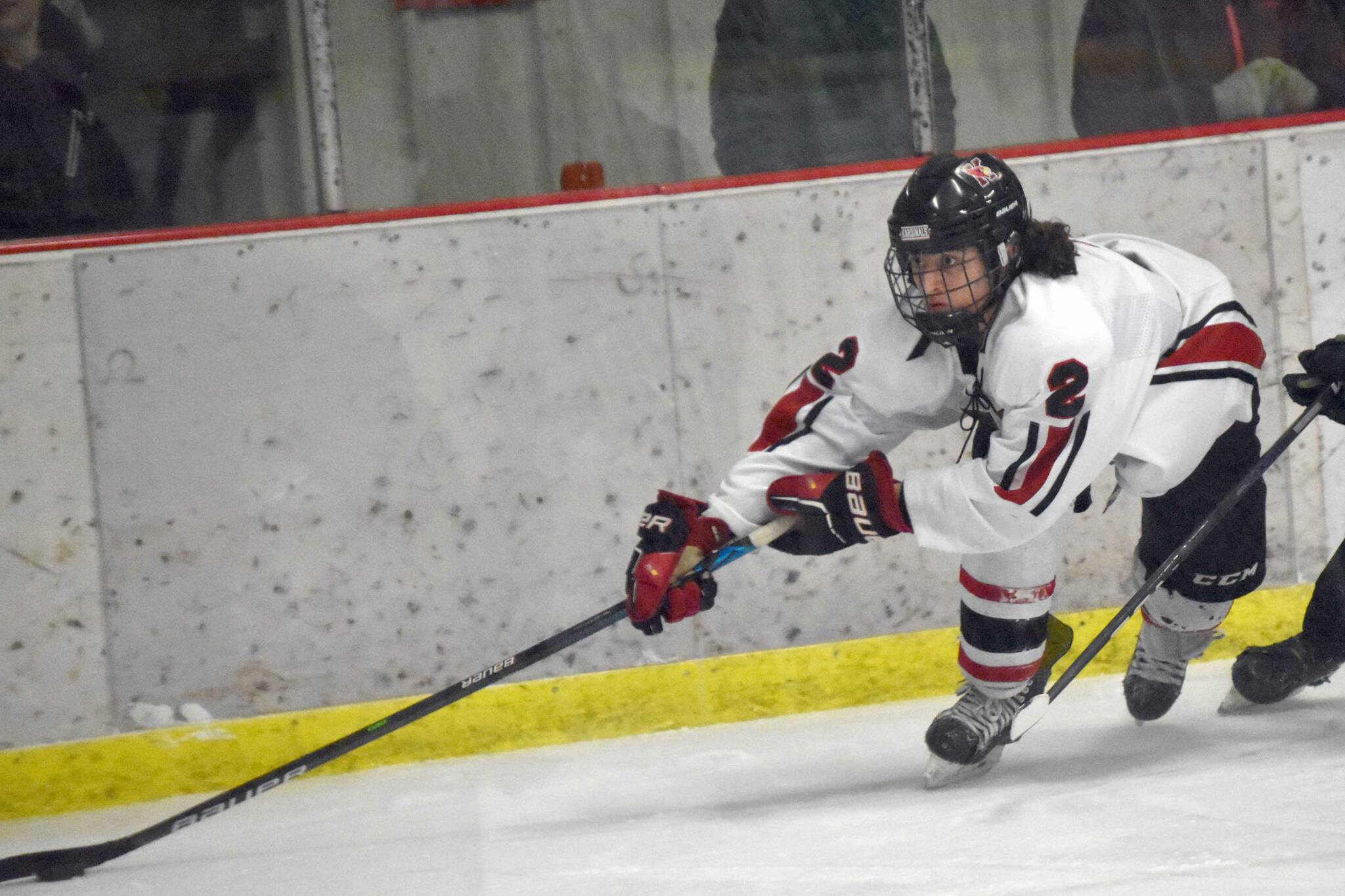 Kenai Central's Logan Mese keeps the puck from Colony's Carsen Lantto on Thursday, Jan. 5, 2023, at the Kenai Multi-Purpose Facility in Kenai, Alaska. (Photo by Jeff Helminiak/Peninsula Clarion)