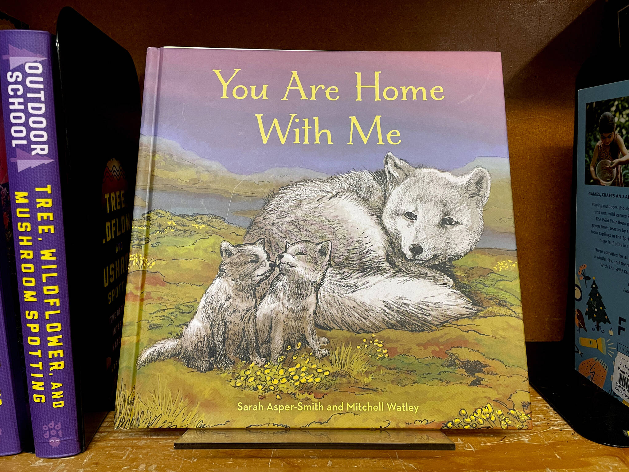 The children’s book “You Are Home With Me,” illustrated by Mitchell Thomas Watley, is shown at a bookstore in Portland, Ore. in this April 5, 2023 photo. Publisher Sasquatch books, owned by Penguin Random House, said Wednesday, it has ended its publishing relationship with Watley after he was arrested on allegations of leaving violent, transphobic notes in stores around Juneau, Alaska. Watley told police he was motivated by fear following a deadly school shooting in Nashville that sparked online backlash about the shooter’s gender identity, court records show. (AP Photo/Claire Rush)