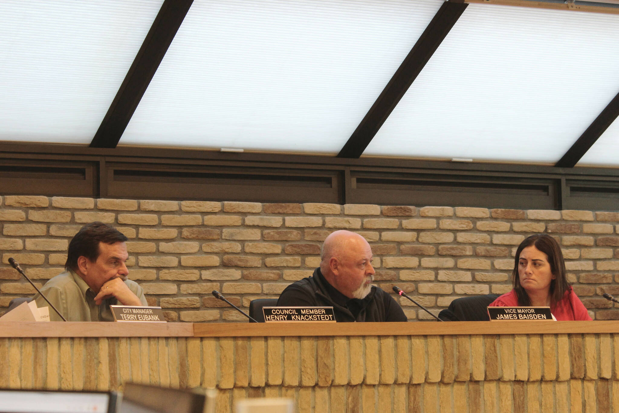 Kenai City Council member Henry Knackstedt (left), Kenai Vice Mayor James Baisden (center) and Kenai City Council member Teea Winger (right) debate a resolution that would have voiced the city’s support for a legislative increase in school district funding during a city council meeting on Wednesday, April 5, 2023, in Kenai, Alaska. (Ashlyn O’Hara/Peninsula Clarion)