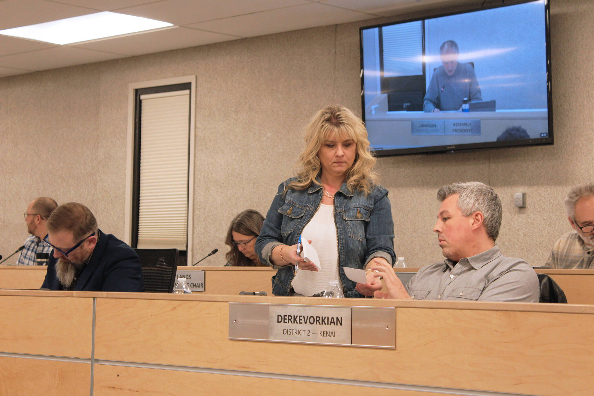 Acting Kenai Peninsula Borough Clerk Michele Turner, left, accepts a ballot from Richard Derkevorkian during an assembly meeting on Tuesday, Jan. 17, 2023, in Soldotna, Alaska. (Ashlyn O’Hara/Peninsula Clarion)