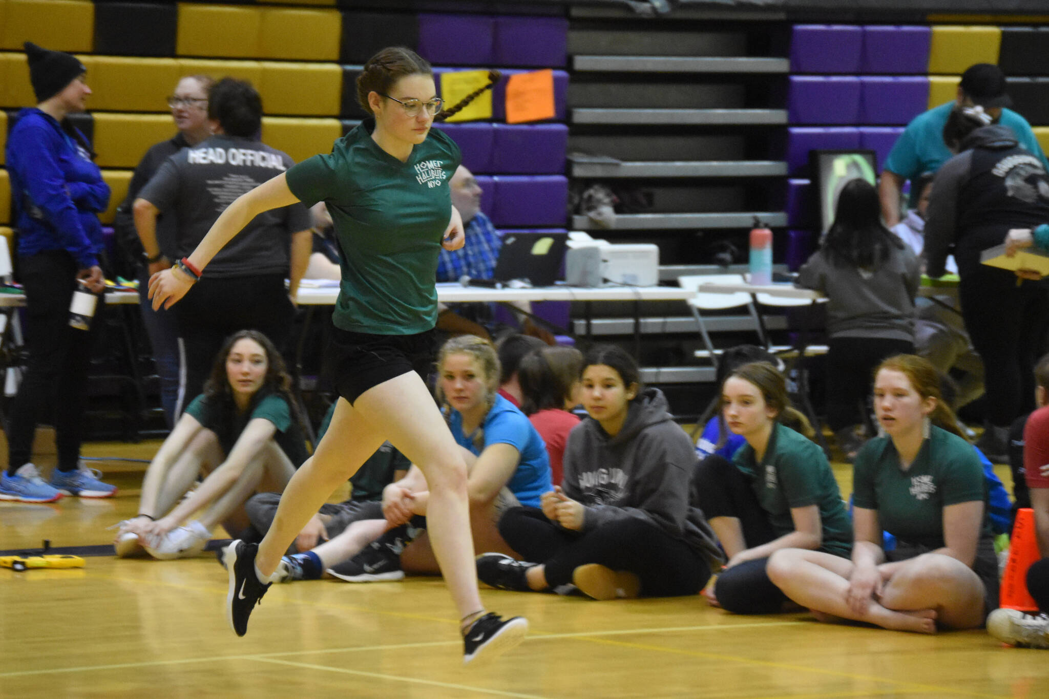 A Homer athlete competing in the senior division performs the Scissor Broad Jump during the Salamatof Tribe Traditional Native Games Invitational at Kenai Middle School in Kenai, Alaska, on Friday, April 14, 2023. (Jake Dye/Peninsula Clarion)