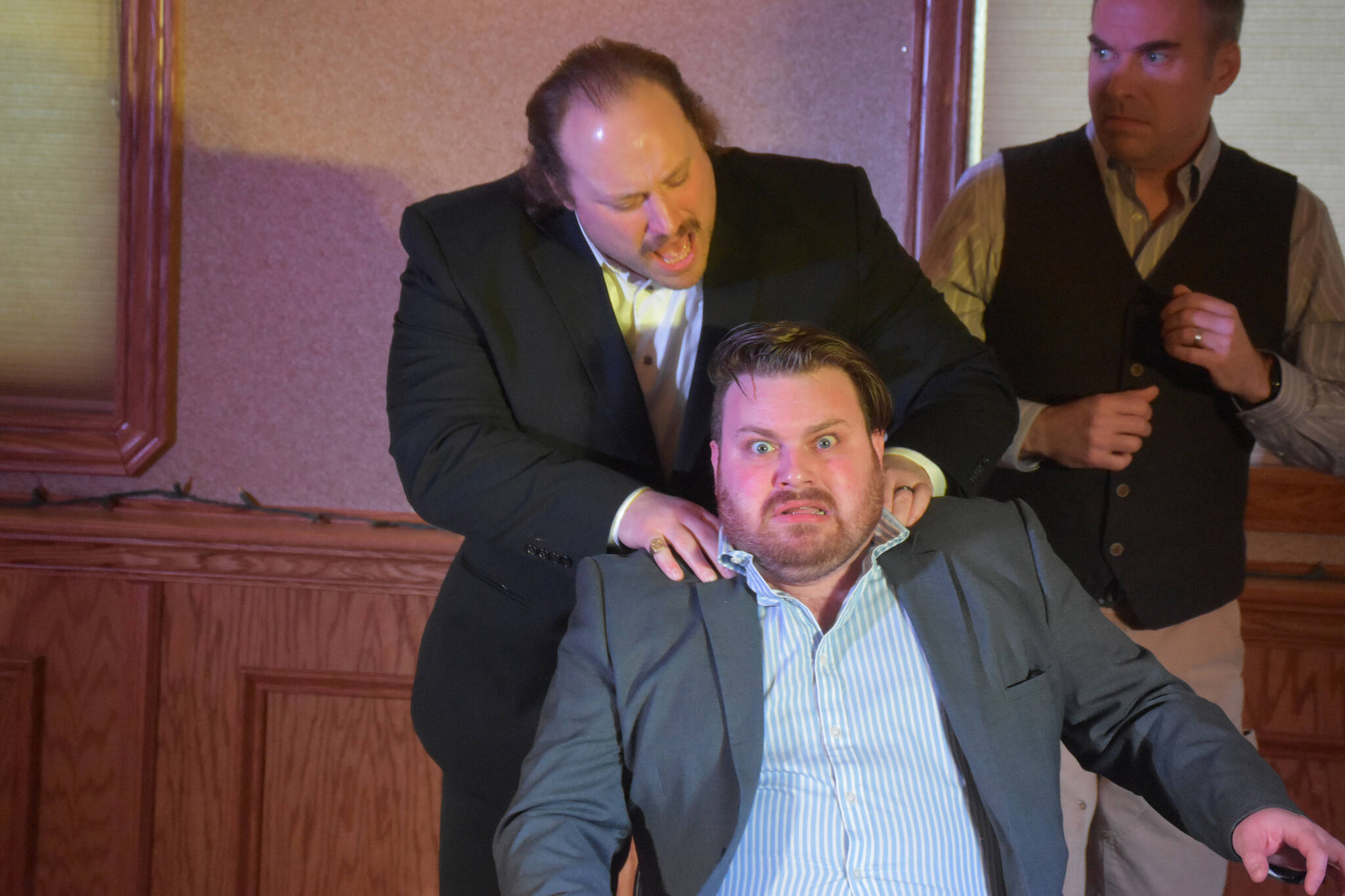 Tyler Payment, as Vito Corleone, acts alongside Joe Spady as Johnny Fontane and Jamie Nelson as Tom Hagen during a rehearsal of “The Codfather” on Tuesday, April 18, 2023, at Kenai Catering in Kenai, Alaska. (Jake Dye/Peninsula Clarion)