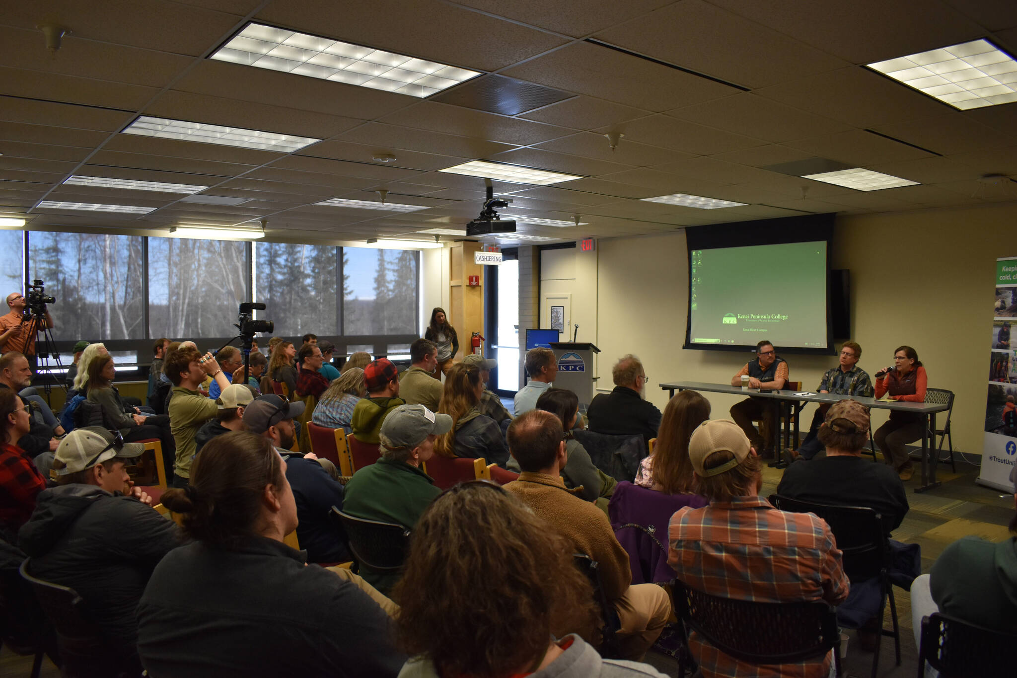 Cook Inletkeeper Science Director Sue Mauger speaks in front of a packed crowd during a panel discussion for the Kenai Peninsula College Showcase “State of the Salmon” on Wednesday, April 20, 2023, at KPC in Soldotna, Alaska. (Jake Dye/Peninsula Clarion)
