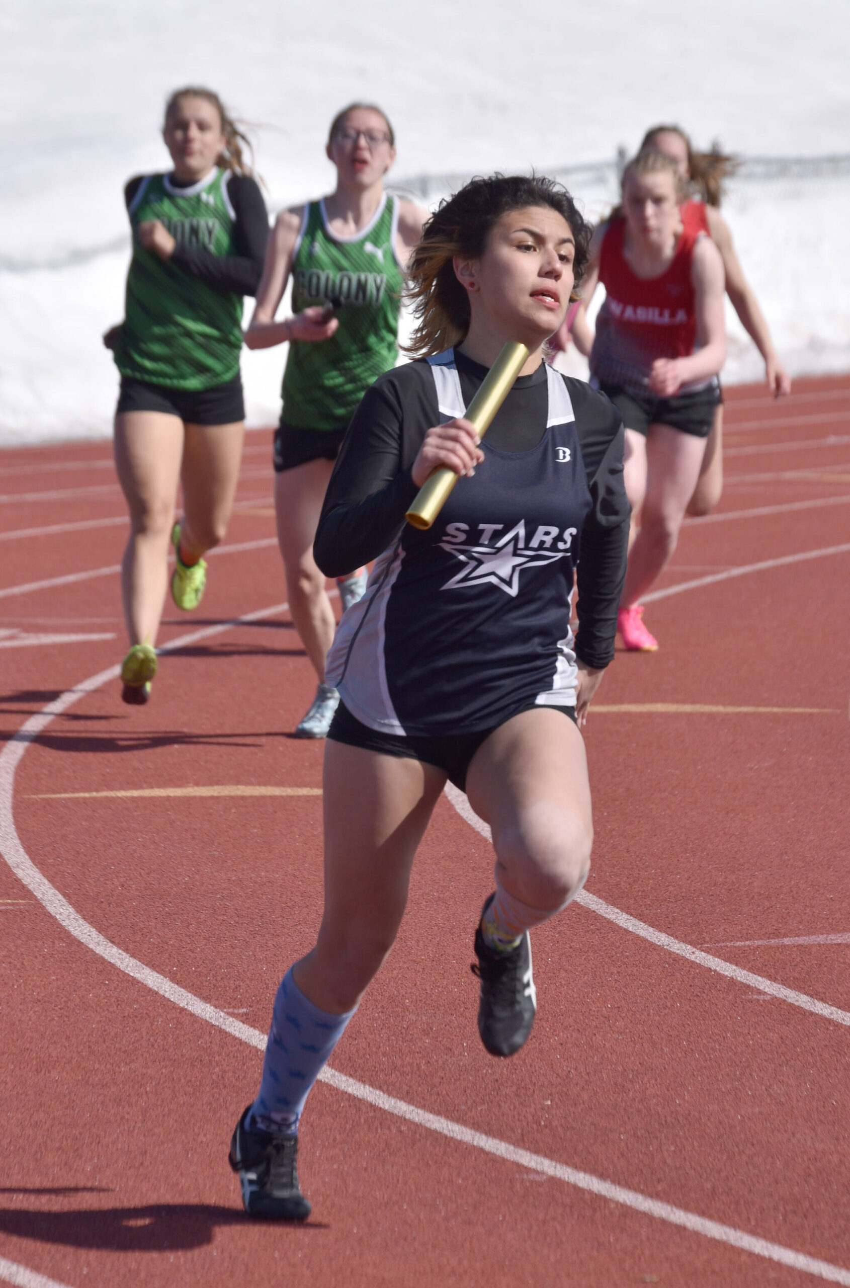 Soldotna’s Angelina Chavarria helps Soldotna’s 400-meter relay team to a victory in the SoHi Invitational on Saturday, April 22, 2023, at Justin Maile Field at Soldotna High School in Soldotna, Alaska. (Photo by Jeff Helminiak/Peninsula Clarion)
