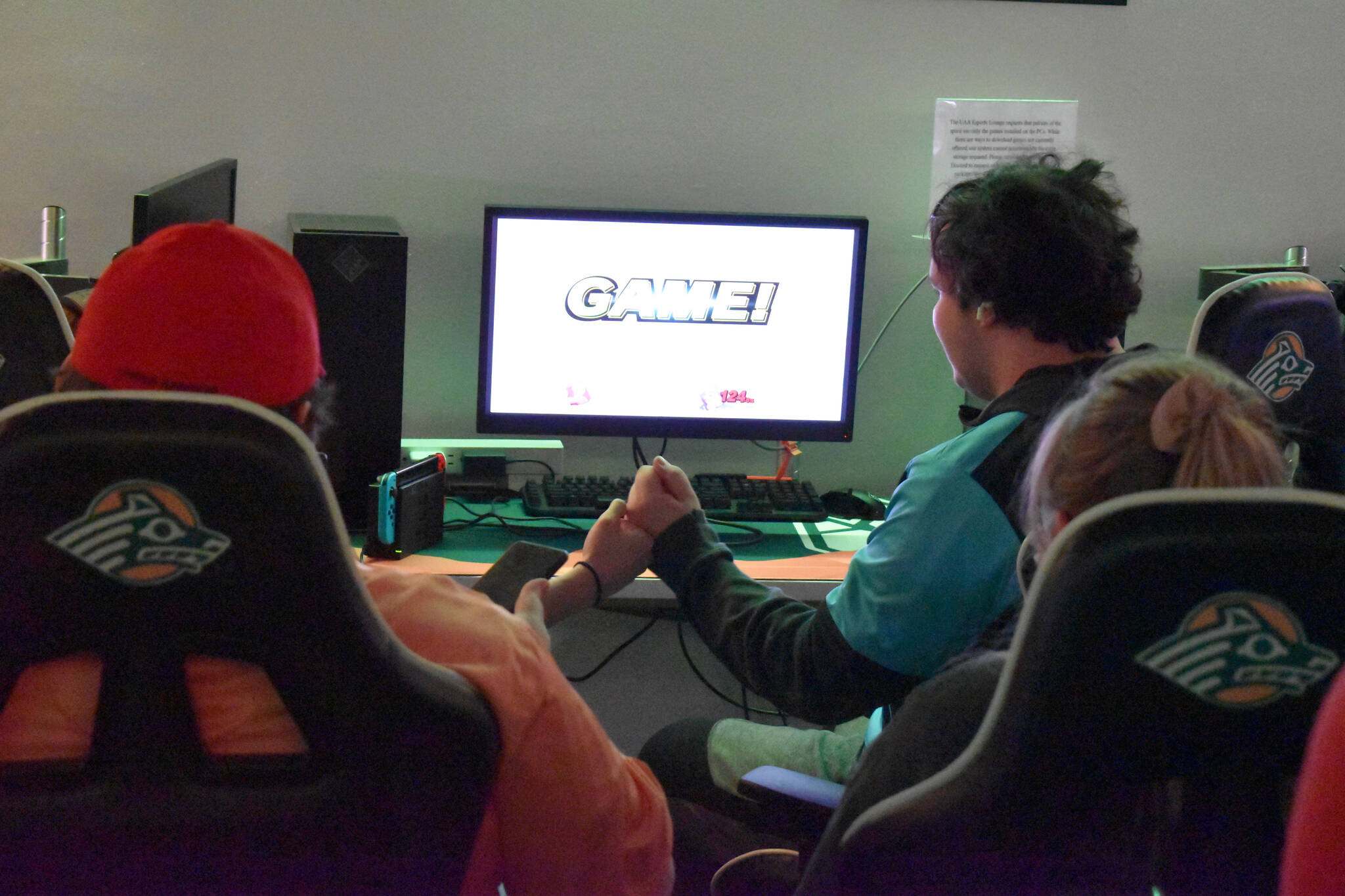 Kenai Centrals Cody Good and Chugiaks Elliott Barnes bump knuckes at the end of the first round of the final match of the Super Smash Bros. Ultimate State Championship on Saturday, April 22, 2023, at the University of Alaska Anchorage Esports Lounge in Anchorage, Alaska. (Jake Dye/Peninsula Clarion)