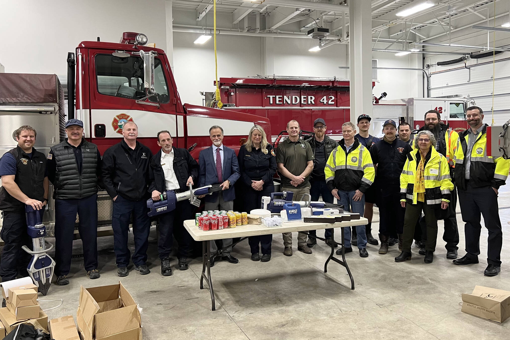 Kenai Peninsula Borough Mayor Peter Micciche (fifth from left) celebrates the receipt of extrication equipment alongside staff from Kenai Peninsula fire departments and the Girdwood Fire Department during a press event at the Girdwood Fire Department on Tuesday, April 25, 2023, in Girdwood, Alaska. (Photo courtesy Kenai Peninsula Borough Mayor’s Office)