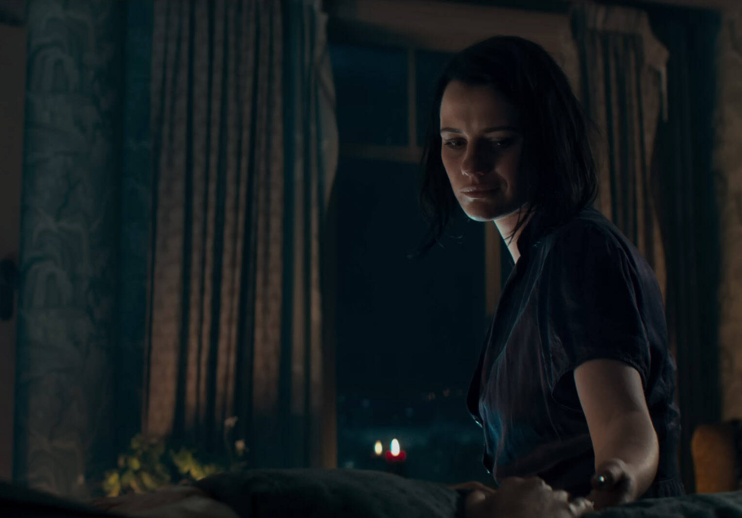 Beth, played by Lily Sullivan, reaches for the hand of her late sister in "Evil Dead Rise." (Photo courtesy Warner Bros. Pictures)