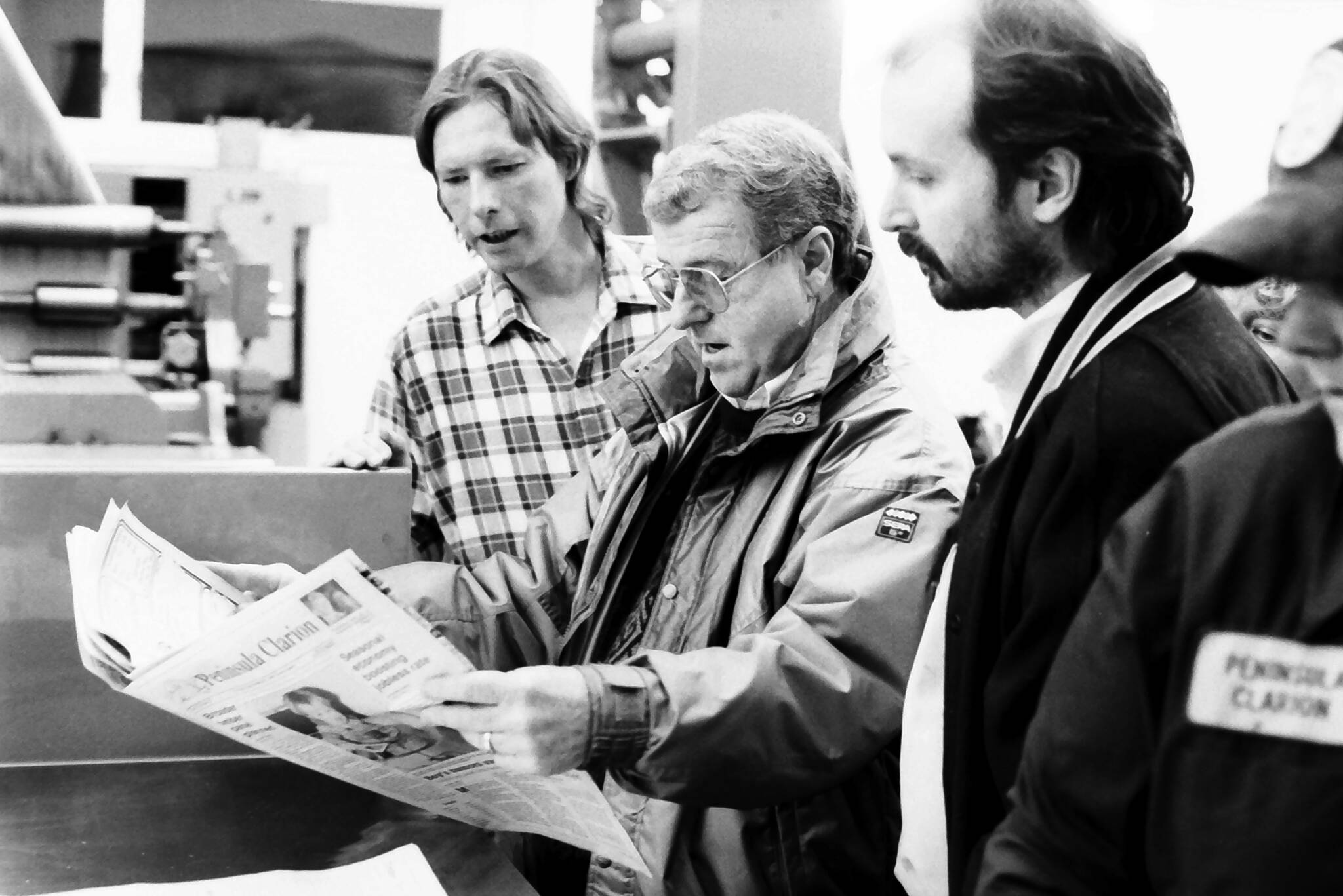 Dick Westmoreland, Ronnie Hughes and Jon Little look over one of the first newspapers to come off the Clarion’s Goss Suburban in December 1992 in the Peninsula Clarion pressroom in Kenai. (Roy Shapeley/Peninsula Clarion)